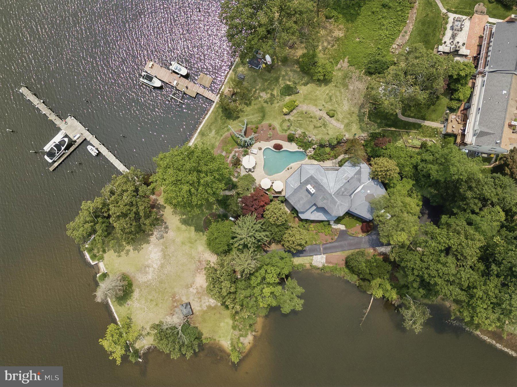 This Severna Park home is a rare find and presents a luxurious waterfront retreat with 109 feet of frontage on the desirable Severn River, featuring deep water (8+ feet) ideal for sail and power boating and the pier equipped with electric and water. The contemporary, multi-level home spans almost 6000 square feet, 6+ bedrooms, 5.5 bathrooms, boasting soaring ceilings, gourmet kitchen, floor-to-ceiling windows, and expansive water views from both inside and out. The interior includes 2 stone wood-burning fireplaces, a luxury master suite, and a large private den/library perfect for a quiet home office. With ample space to accommodate an in-law or au pair suite, this home offers versatility and comfort. Outdoor amenities include a swimming pool with waterfalls, a hot tub overlooking the water and western exposure for stunning sunsets. Located in highly sought-after Severna Park, this home nestled in a serene setting has so many features and an opportunity you don't want to miss!