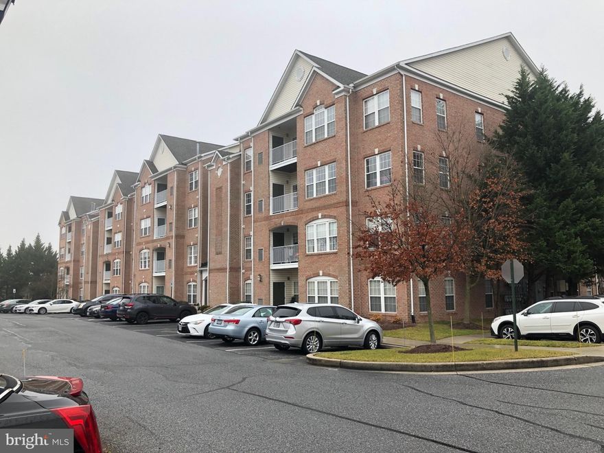 Security lock at building front door.  Elevator in entry hall.  Top floor unit features cathedral ceilings in the LR, Kitchen and Main Bedroom.  It's all about space in this 2 BR, 2 Bath unit.   Large bedrooms, large baths, lots of storage closets and the main BR offers a walk-in closet which stores "four seasons of clothing".  Main BR also has a bump out which may serve as a home office w/ wooded view.   And the main BR bath is BIG and has a jetted tub.   Open flow in the living  & kitchen space, with breakfast room offering the 4th floor walkout to a balcony/deck looking over a wooded area and the western sunset.  The formal dining space offers an opening which may be set with doors to have a private office.   Kitchen features lots of 42" cabinets & a pantry.  SS refrigerator.  In unit, closeted full size laundry equipment  across the kitchen hall.  Assigned parking space is 50' from the building entrance.  Lots of visitor parking on the same lot.  This location puts you 5 minutes from interstate 95 and 2 minutes from Belair Road.  Large, public  park is less than a mile from home, as are restaurants and fitness center.   Monthly condo fee is $275. at this home.
When visiting for a look or tour, please use the unmarked parking spaces.