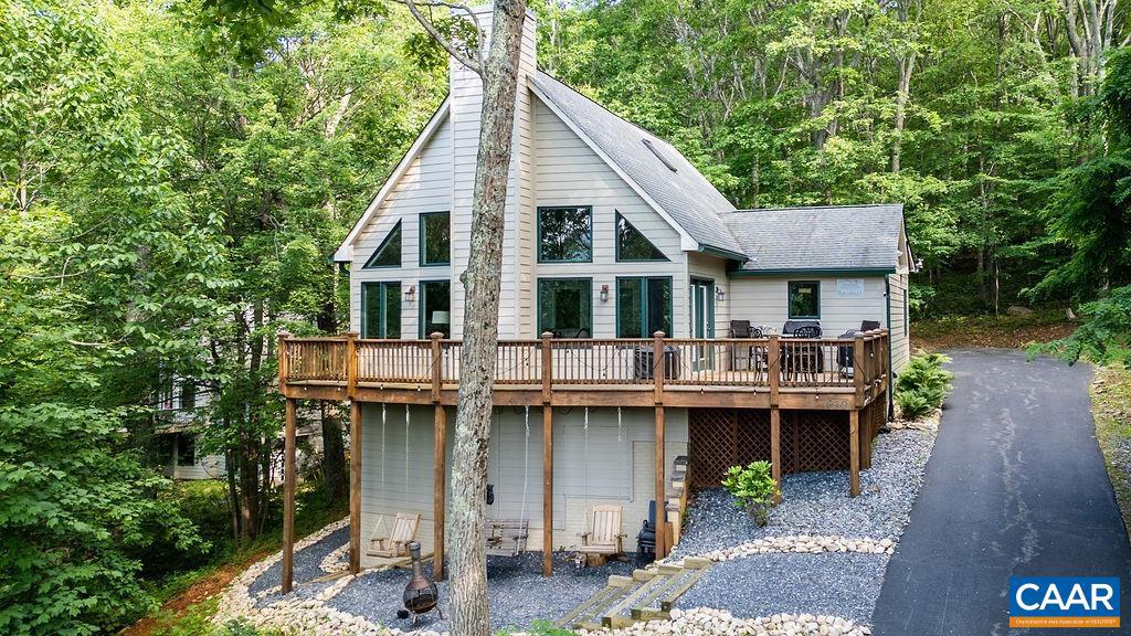 This home is absolutely pristine! Walk just a few steps from your driveway to the trail leading right out to the Tyro slope. New remote controlled gas log insert, radon mitigation system, security system, new gutters & guards and PVC band board around deck. Featuring a large deck and with views across to the Ridge with swings located below in a beautifully landscaped area. Driveway is paved with parking close to the front door and only a couple of steps to the porch. Main level living with two bedrooms and two baths on the main level. Upstairs boasts a private Owner's Suite and an additional flex room that can be a study or overflow sleeping area. Situated on a completely finished walk out basement.,Granite Counter,Wood Cabinets,Fireplace in Great Room