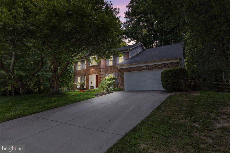 Discover this stunning detached home situated on a tranquil cul-de-sac, backing to picturesque woods. Inside, the home features an airy family room with high ceilings and a cozy seating area, a den or office, and formal living and dining rooms. The beautifully renovated kitchen is a chef's dream, with sleek stainless steel appliances, an island, and a breakfast area.  The oversized window over the kitchen sink provides a picturesque wooded view.  The primary suite offers a renovated full bath with a dual vanity and a spacious walk-in closet. There are three additional bedrooms and a full hall bath on the upper level. The finished lower level provides extra living space with a full bath with a cedar closet and walks out directly to the backyard. The large deck is perfect for outdoor entertaining. Complete with an attached 2-car garage, this home combines comfort and convenience in a serene setting. A tot lot is mere steps away down the path right off of the cul de sac. Additionally, the Dorsey Hall Village Center is a short walk from the home, offering shopping and dining options. Roof completed in 2014, HVAC replaced in 2015.