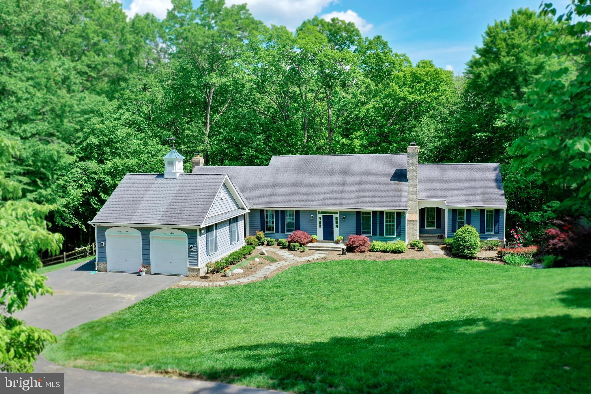 This sweetly charming 5-bedroom, 4-1/2 bath Cape Cod home on a park-like 5-acre lot is quietly spectacular! The main level owner’s suite offers comfortable one-level living, while all the large and graciously finished rooms provide approximately 5,600 square feet of living space just waiting for you, your family and your guests. Stroll and explore the woods, play on the sunny front lawn or sit outside on one of three decks, surrounded by exquisite gardens, mature landscaping and natural woods. The hardest part will be deciding which is more lovely, the inside or the outside!
This home’s gleaming hardwood floors and main staircase have just been refinished (May 2023), all of the carpet is newly replaced (May 2023), and all the bathrooms have been updated! The two upper-level bedrooms are perfect for a quiet retreat, while the two lower-level bedrooms plus the huge rec room offer lots of space for fun gatherings. From the formal living and dining rooms to the warm and inviting kitchen and family room, this house is move-in ready and waiting for you.
Located just over a mile from the historic town of Clifton, Virginia with its wonderful restaurants and shops, this lovely home in the Morwood subdivision enjoys a small-town feel while having convenient access to major commuter routes such as Rt 123, the Fairfax County Parkway, or I-95. For outdoor enthusiasts, pop over to nearby Kincheloe Park, Hemlock Overlook Park or Bull Run Park Marina with all those sports fields, hiking trails, fishing, and kayaking just minutes away. Paradise Springs winery in Clifton is a lovely place to gather with friends, and the nearby historic towns of Fairfax, Occoquan and Manassas offer even more dining and shopping to explore. Schedule your tour of 7507 Morwood Trail today and you won’t be able to wait to make it your new home!