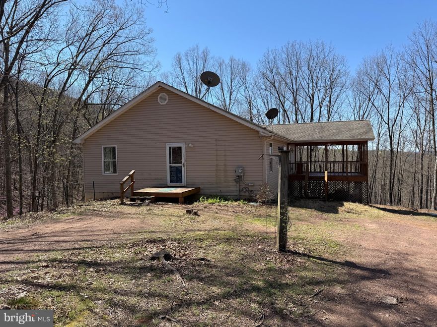 VERY REMOTE - This rancher is situated on 5 wooded acres and features: 3 Bedrooms, 2 Baths, Main Level Laundry, Kitchen -Dining-Living Room with pellet stove to warm up to.  Unfinished basement for storage or to increase your living space.  Enjoy the large covered porch.      Heat pump with central air, well and septic.  This property is unrestricted with no road maintenance agreement therefore a cash or conventional loan will be needed to purchase.