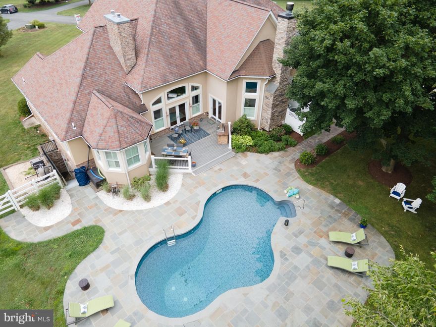 Close to the Montgomery County line, this  gorgeous contemporary is located in the Urbana School District and sits on 2.63 acres in Clarksburg  (Fred. Co.) with 4 bedrooms, 4.5 bathrooms, in-ground pool, hot tub, finished basement w/finished rooms that could be used as additional office/bedrooms, main level primary bedroom with gas fireplace, trey ceilings and exterior door that leads to pool.  Other features include: Brazilian hardwood floors, laundry/mud room on main level, media room in basement, lots of closets in finished basement, huge storage room, Jack & Jill bath on upper level  and gas fireplace in formal living room. Motorized window shades in primary bathroom and office.  All bedrooms have walk-in closets and access to a bathroom.  Construction done in 2014: Beautiful 15' x 13.5' office addition w/3 triple windows, 19.5' x 19.5' screened porch with coffered ceilings,  13 foot high wood-burning stone fireplace in family room with Oregon River Stone (gas starter) and New England (New Hampshire) wood crafted mantel, 20' x 20' parking area off driveway with 2 additional parking spaces.  Construction in 2017: Flagstone hardscape, pool deck and sidewalk to screened porch and driveway,  22.5' x 16' deck, 7' 10" x 7' 10" in-ground 7 person hot tub with flagstone deck, Bull gas grill with gas line to house, new shower in primary bathroom.  In 2021: upper level and stair railings painted, new carpet on upper level and basement, new stainless refrigerator and dishwasher, 1 of 2 HVAC units replaced. 2022: basement painted, extensive landscaping, replaced all outdoor lights with Charleston lanterns and auto timers.  New pool pump in 2023.  Square footage in public record is believed to be incorrect.   It does not take into account the office addition. Some furniture conveys too.