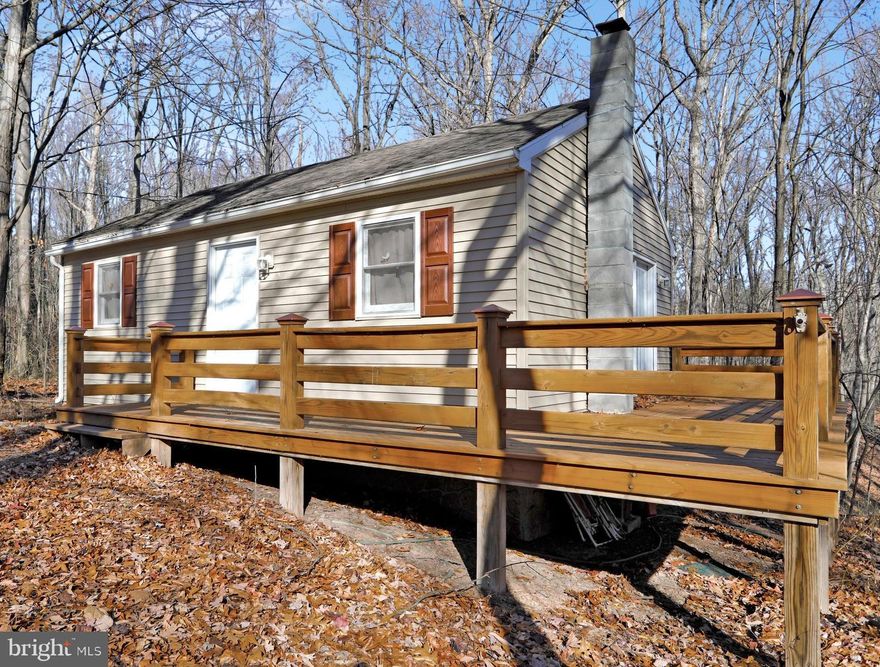 IF YOUR TRYING TO GET AWAY FROM THE HUSTLE & BUSTLE & GET SOME PEACE AND QUIET, THEN LOOK NO FURTHER. THIS TWO BEDROOM & ONE BATH HOME SITS ON 6 ACRES+- SURROUNDED BY WOODS. SIT ON YOUR DECK AND WATCH THE WILDLIFE & ENJOY THE QUIET THAT SURROUNDS YOU. ABOUT 20 MINITUES OUTSIDE HISTORICAL BERKLEY SPRINGS WITH IT'S SPAS, FINE DINING, SHOPPING AND ARTS DISTRICT. APPROXIMATELY TWO HOURS FROM WASHINGTON DC & BALTIMORE. A GREAT PLACE TO GET AWAY TO ON WEEKENDS OR TO MAKE YOUR PERMANENT RESIDENCE. LARGE WELL BUILT DECK FOR FAMILY GATHERINGS OR ENTERTAINING. SIT BY THE WOOD STOVE ON COLD DAYS AND RELAX & ENJOY MOTHER NATURE FROM THE LARGE SLIDING DOORS THAT GO OUT TO THE DECK.  NEW CARPETING  &  APPLIANCES. EXPLORE THE UNRESTRICTED 6 ACRES+- THAT SURROUND YOU.  NO HOA OR ROAD MAINTENANCE FEES.