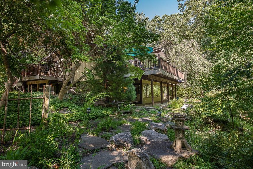 Finally, the home you have been waiting for! Your own private oasis featuring spectacular views from every room!  Welcome to 1997 Rochambeau Dr. This stunning contemporary is located in the TE School District.  The home features a gourmet kitchen with custom cabinets, a gas cooktop, a subzero refrigerator, and double ovens.  The open floor plan contains a formal living room with a wood-burning fireplace, a formal dining area, and spacious office with built in custom shelves.  Open your  sliding door which lead out to an expansive  Trek deck.The Master suite is also on the main floor, featuring a walk-in closet, a private sitting area, and a  master bath with a steam shower and soaking tub.The lower level has 3 full bedrooms and a large mudroom, full bath, and an spacious family room, with room for an office area including a  wood stove.  There are sliders leading to an outside lower level deck steps away from a koi pond and a red bridge to the woods. There is a side level yard and garden.  Bonus features include plenty of storage with a 3-car garage and an additional workshop with its own separate heating and AC zone. This home has 4 acres of pure privacy. You must experience the magical tranquility of this home. If ever there was a place to  shelter in place  this home has the beauty and serenity of being one with nature and yet the convenience of location, when you want to venture out!  Located  just minutes from KOP and downtown Devon,  and the "Main Line Area."   Minutes  to routes 476, 76 and PA turnpike and R5 train stations, including great shopping and restaurants. Easy access  to  biking  and running trails at Valley Forge Park, the  Perkiomen  and Schuylkill River trails.Call Now for a Private or Virtual Tour.