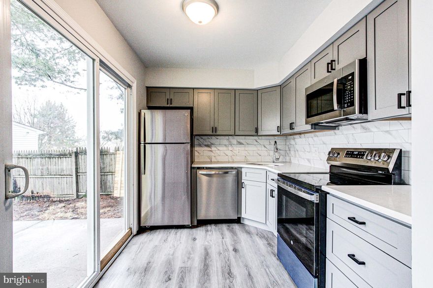 The pictures tell the story on this one.  Just unpack your bags and start enjoying this completely remodeled 3 Bedroom / 1.5 bath townhome.  Note: Large 3rd story finished attic could be 4th bedroom, office or playroom.  Just about EVERYTHING is brand new.  New windows, floors, heaters, light fixtures and fans throughout the entire house.  Inside doors have been replaced with new 6 panel doors.  Kitchen completely overhauled with new easy close cabinets and appliances.  Dishwasher, Microwave, Range and Refrigerator ALL brand new.   Granite countertops installed with a beautiful matching tile backsplash.  Kitchen and Dining Room both have sliding glass doors leading out to a fully fenced in yard for privacy.  Yard also has a locking gate for easy access to the side of the property.  Both bathrooms completely redone with new toilets, vanities and beautiful tile floors.  The main bath also has a brand new shower and tub.   New front door with sidelight allows lots of natural light.  The 2nd Floor has 3 bedrooms that have been freshly painted, and include new windows, flooring and heating.  Additional huge finished 3rd Floor can be used as a 4th bedroom, office, nursery or even a giant playroom.  Roof recently redone just 2 years ago.  Townhome also has 2 spots for off street parking.