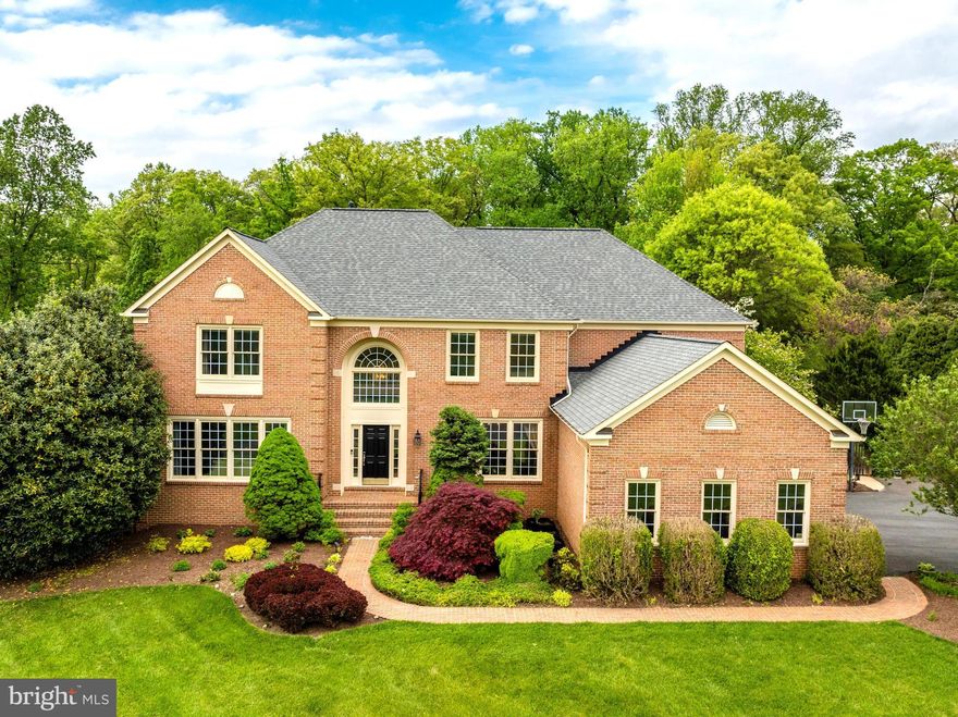 Introducing 511 Nalls Dairy, an impressive brick colonial situated on 1.72 beautifully landscaped acres. Located in Great Falls and tucked away on a quiet cul-de-sac, this impressive property offers the ideal outdoor setting. With both wooded and bucolic vistas, a dream pool/spa combo and a 692 sq ft deck, this property is perfect for entertaining family and friends. Walk into this meticulously maintained home featuring many upgrades throughout, including hardwood floors, crown molding and trim, custom windows, recessed lighting, built-ins, a brick centerpiece fireplace, and more. You're going to fall in love with the spacious layout. A separate dining room, front sitting room and office with built-ins and french doors cater to more formal gatherings while the light filled two-story living room is ideal for more casual family time. The eat-in kitchen features stainless steel appliances and plenty of room for entertaining. 4 generous bedrooms upstairs include a primary suite with two walk-in closets and a spa-like en-suite bath. The finished walk-out lower level includes a spacious living area and a full bedroom and bath. Utilize this space as an in-law suite, to host family and friends, or as a bonus rec-room for play time! The three car garage provides additional space for storage. Revel in the private and tranquil outdoor space. Enjoy a spacious deck off the kitchen, incredible backyard pool/spa, a separate patio and beautifully landscaped grounds. Discover your green thumb with plenty of room for gardening. Located in the desirable Langley High School pyramid and minutes to Tysons Corner, I-495 and the GW Parkway, this is true lifestyle property in the heart of Great Falls. Welcome home!