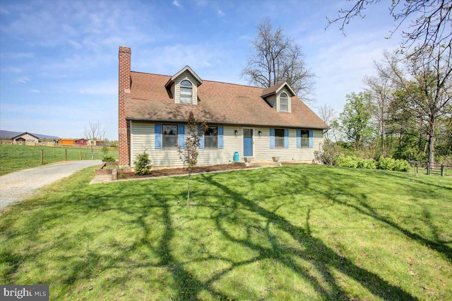 Nestled on a picturesque 1.72-acre lot with a serene stream, this charming Cape Cod-style home offers a perfect blend of comfort and functionality. The property features an open-end garage/storage building, a stable/shelter with a tack or feed room, a small ring, and a fenced pasture—ideal for equestrian enthusiasts. The main level boasts a spacious bedroom with an en-suite bath, complete with a soaking tub, separate shower, and a walk-in closet. The updated kitchen is a chef's dream, offering ample cabinet and counter space, a stainless double oven, electric cooktop, stainless refrigerator, under-cabinet lighting, and a breakfast bar. It seamlessly connects to the dining area, which has access to the deck. A convenient hallway half bath is also located on this level. Upstairs, you'll find two large bedrooms and a full bath with a tub/shower combination. The full basement includes finished space that can serve as an additional bedroom or a perfect office, and a family room with a beautiful brick wood-burning fireplace. The unfinished portion houses the laundry area and offers excellent storage space with a walk-up areaway to the outside. The recently replaced heat pump/central AC system includes an oil backup system and UV light, with supplemental electric baseboard heating available throughout the house. This charming home is a rare find, offering both modern amenities and rustic charm in a tranquil setting. Don't miss the opportunity to make it yours! East fence, constructed by a previous owner is partially encroaching on neighboring property and may need to be removed as a condition of the sale.