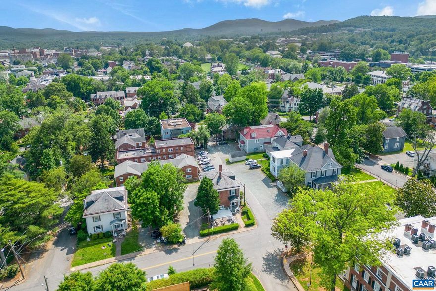 Incredible investment opportunity near UVA: fully leased through May 2025.  C: 1900 brick house on a spacious offers oodles of off street parking. You'll appreciate the charm and character (high ceilings, hardwood floors, arched doorways) which is further enhanced by modern systems, and renovated kitchen and baths. The home is well maintained by the current owners who are ready to pass the baton, along with their list of local service providers who keep the home in top-notch condition. 1604 Grady Avenue is an ideal property to add to your investment portfolio as the 8 bedroom, 6 bath house is sought after by UVA students every year; recent Zoning changes (Residential Mixed Use, 5 stories) allow for increased density and expansion on site. The possibilities are endless. Come see what all the fuss is about. Floor plans included with photos. Showings by appointment only, with listing agent present, so not to disturb the current tenants.