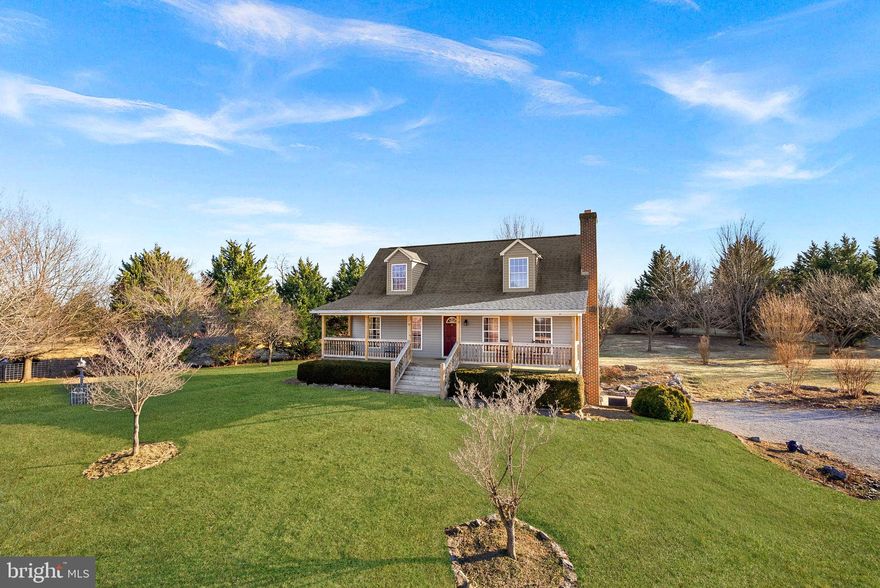 Great opportunity to make this lovely cape cod home your own! You'll love this property set on a beautiful 7 acres with barn and fenced off paddocks. This property is conveniently located off of route 7 outside of Berryville and set far back down a long driveway creating a private and tranquil setting. In the spring time the flowering trees and mature landscaping are simply beautiful. Approaching the home you will love the full front porch.  Upon entering you will notice the solid hardwood flooring throughout and family room with wood burning fireplace. There is tons of natural light flooding the main level. The kitchen is open with tons of solid wood cabinetry and counter space, windows overlooking the property and an ample dining area. The primary bedroom and an additional bedroom/den are located on the main level with an adjacent full bathroom. The upper level has two bedrooms and a full bathroom. The property is fully fenced and would be a wonderful place for livestock, chickens or other animals. * NEW ROOF: 2017* Property being sold AS-IS. Welcome home!