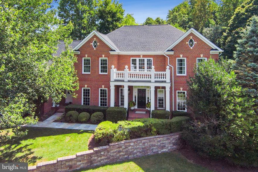 Significant price adjustment!  Come tour this beautiful home in person--Open Sunday, Oct 29, 1-3 pm. Gracefully set atop a gentle knoll, the stately presence of this elegant brick home immediately captures one’s attention.  Manicured landscaping and mature trees on this 1.1 acre corner lot are the perfect backdrop for this handsome five-bedroom estate home. The exterior, with its combination of private deck, stone patio and inviting firepit, are rivaled only by the timeless architecture and sun-drenched spaces that await inside!
The home offers the perfect combination of both an open floor plan, with the Kitchen and Breakfast Room flowing seamlessly into the two-story Great Room, and private spaces with the Office secluded behind French doors and the inviting Living and Dining Rooms which greet you upon entry into the Foyer and set a welcoming tone for guests.
Upstairs can be accessed by either the elegant main stairway or by the back stairwell which offers easy access to the Kitchen.  Four of the five bedrooms can be found on the upper level, including the grand Owner’s Suite which encompasses a large bedroom, dressing room with coffee/wine bar, walk-in closet and spacious, updated full bathroom.  The secondary bedrooms on this level all have en suite full bathrooms, and the entire upper level has sumptuous, brand new carpeting.
The spacious finished walkout lower level, in addition to the fifth bedroom and updated full bathroom, offers a variety of fabulous entertaining and work spaces as well as a generously sized storage room!  Enjoy a drink at the Wet Bar.  Play a game of table tennis in the Game Area.  Watch a movie in the Rec Room.  Find your Zen moment in the Yoga/Exercise Studio.  Or, get some work done in the second Office.  The home has been meticulously maintained and updated (2023: flagstone walkway, new carpeting, new bathroom fixtures, deck painted, interior painted.  2022: new roof, new kitchen appliances and sink, powder room updated, new 75 gal hot water heater, exterior painting, new garage doors, picture windows replaced.  2018: UL A/C replaced, built-in wine chiller in kitchen, owner's bathroom updated, lower lvl bathroom updated.) This beautiful estate home is located in the tony community of the Estates at Lowes Island, which is masterfully sited between a meticulously maintained golf course, the Potomac River and nearly 500 acres of parkland filled with an abundance of walking and horse trails.  The community also has a private pool, tennis courts and playground all for a very low HOA fee.  With the serenity of this peaceful neighborhood, you’ll forget that you’re just minutes from Dulles airport, an abundance of dining and shopping venues and a number of metro rail stops.  Floor Plans and a Site Plan are located in the Documents Section of the MLS.