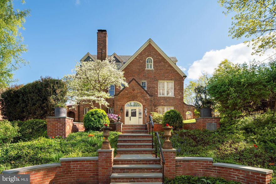 Sited high over the Glover Park neighborhood, the famed "Manor House" offers a once in a lifetime opportunity to own a piece of history. Thoughtfully designed by architect M.C. Nichols for investor Michael B. Inscoe in 1931, the Manor House was renovated and restored to perfection by its current owners. This 4,700 square foot residence was originally constructed over 2 years using the finest brick and masonry materials along with sharks tooth slate shingles for the roof. Copper gutters, copper trim, and leaded glass windows add to the character and quality found throughout. The Manor House welcomes you with wide slate steps, a themed compass walkway and front, side and back lawns all enveloped in privacy. Holly hedges, a dogwood tree, azaleas, wisteria and seasonal flowers provide privacy and lush landscaping which can be seen from all rooms within the house.   Under the direction of well known designer Jean Smith, the current owners renovated and restored the residence using exquisite materials, lighting and hardware. Fine elements include custom mantels, custom stone work and themed millwork. The landscaping was designed with year round foliage and color to provide for breathtaking views and privacy.  The spacious main level foyer opens to the living room, family room and center hallway. Fireplaces and French doors are found in both rooms and each room opens to side patios and gardens. The gourmet kitchen with island is open to the main dining room currently used as a family room. Masterful tile work was designed for the backsplash of the kitchen. One of two powder rooms is neatly tucked away at the back of the kitchen. Top of the line appliances complete the cooks dream kitchen. The formal dining room with corner windows is located in the center of the home. The center hallway follows and leads to a surprise sunroom with walls of glass. The back garden, lawn and garage can be accessed from the sunroom.   The second level provides for three spacious bedrooms all with corner windows. Two charming tiled baths are also found on this level, both with original tile work in mint condition. The third level owners suite provides a fourth large bedroom, private marble bath, dressing room and multiple closets. Views of the National Cathedral are found from the front dormer windows. This level lives like a guest suite at the Hay Adams hotel. The daylight walkout lower level includes a recreation/family room, second powder room, second kitchen, and a fifth bedroom with fourth full bath. Guests will want to stay forever. A private driveway plus one car garage provide ample parking. The Manor House is located in upper Georgetown just north of Georgetown University and Hospital and approximately 7 blocks from the best of Georgetown's dining and shopping. 10 minutes to National Airport, 15 minutes to the White House and 25 minutes to Dulles Airport.