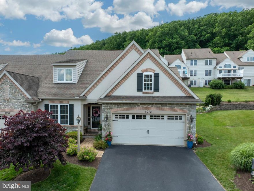 WOW Former Model Home in the Gold Star 55+ active adult community, The Woods at Rock Raymond! This is the one you have longed for! Relax and let the HOA take care of the grounds and home exterior! Gorgeous End Home boasts an entrancing rear patio, accented by an attractive stone wall and adjoining sunny  open space. The absolutely enchanting sun room with volume ceiling lets you enjoy the outdoor beauty, even in the rain and snow! Find your bliss in this delightful haven- whether inside or out! Elegant, upscale Luxury Vinyl Plank added throughout the main interior living area ---creating an even surface for anyone with mobility concerns. Cocoon in the stylish open home center with the upgraded kitchen,  cozy breakfast room,, and dramatic Great Room! The updated kitchen features a 5 burner stainless steel range, tile backsplash, quartzite counters/ breakfast bar and extra deep sink. Relax in the adjacent great room with vaulted ceiling and impressive, stone, gas fireplace. A star-worthy dining room, accented by a custom tray ceiling, welcomes family and friends for memorable dinner parties OR locate your exceptional first floor office here if dinner parties aren’t your style!  The luxe, main floor primary suite boasts an elegant ensuite bath with soaking tub, solid surface shower and double vanity. The efficient, first floor laundry and powder room complete the easy-stepper main floor.  The pretty staircase, with gleaming hardwood treads, leads to two, large second floor bedrooms (one with two, BIG walk-in closets--one used as a home office Nook.) A comfy loft makes an inviting reading and relaxation lounge area for guests! If you need more space, take a look at the huge, ready-to-finish basement with egress window- imagine the possibilities-- For hobbies, fitness and fun space!  The attached, two car garage houses your treasured vehicles. Updated central air and water heater are "icing on the cake!" Hurry to visit this special property!