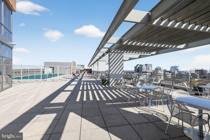 Rare 4th-Floor Gem at The Odyssey | Rooftop Terrace & Exclusive Entertaining Spaces

Discover a rare opportunity to own one of The Odyssey’s most sought-after residences — a sophisticated retreat that defines elevated Arlington living. This exceptional home combines modern elegance with resort-style amenities and breathtaking views of the D.C. skyline.

The open-concept living and dining area flows seamlessly into floor-to-ceiling glass doors that open onto a private outdoor balcony —perfect for sunset gatherings, alfresco dining, or quiet evenings under the stars. Inside, designer finishes, rich hardwood floors, and a gourmet kitchen with premium stainless-steel appliances create an atmosphere of effortless luxury.

Residents enjoy access to The Odyssey’s exclusive rooftop deck, featuring panoramic city views, an outdoor pool, and stylish lounge areas. For private gatherings, the billiards room and club lounge offer refined spaces to relax and entertain.

Perfectly situated in the heart of North Arlington, just moments from Metro, fine dining, boutique shopping, and Georgetown, this residence delivers the best of urban convenience with the privacy of a high-rise sanctuary.