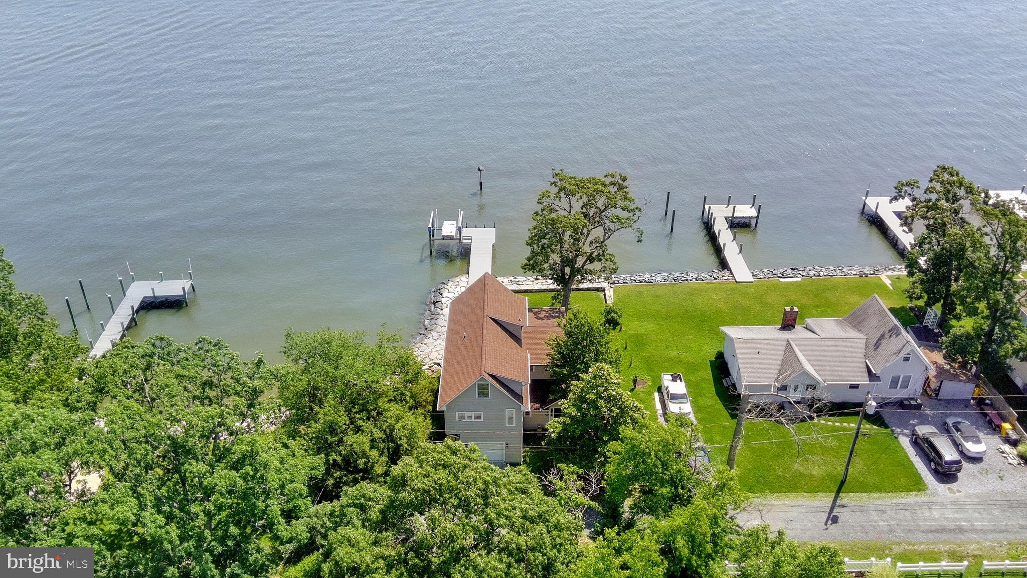Welcome to the Chesapeake Bay! Relax while sipping your morning coffee or unwinding with a glass of wine. This waterfront cottage offers over 3000 sf of living space with panoramic views from every room! Unique features include wood beams on the first and second levels; two staircases access the second level; authentic cedar doors, closets, and drawers take you back to the 1930s; while the minimalistic first level gives a more modern feel. Take a stroll on your private pier or kayak around to Jack Creek Park for an afternoon hike. Enjoy the Felicity Cove community pier with neighbors or take quiet walks through the nearby Shady Grove wooded trail. Living on the water never felt so peaceful!
