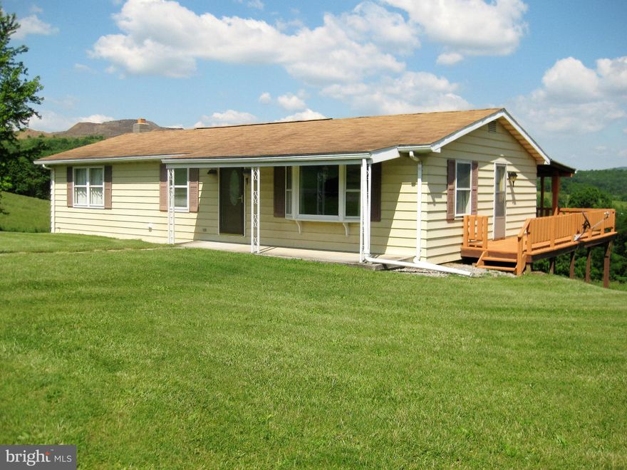 Enjoy stunning views from a large wrap around porch that adds 500 + sqft of covered outdoor living space! New front door with storm door; new sliding doors. Family room in basement has a wood/coal burner and a NEW full bath. Main floor laundry can be easily converted back to a bedroom. Seller has made several recent improvements including upgraded outlets and bath. All of this on 1 acre!