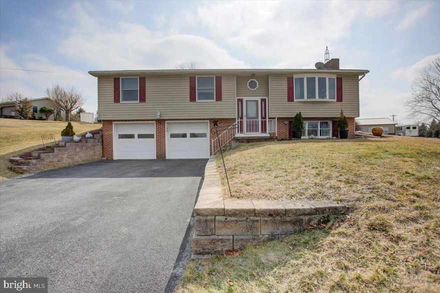 This meticulous home with beautifully maintained exterior welcomes you! Thoughtfully expanded and updated, this home offers an inviting atmosphere, abundant natural light, and a layout designed for everyday living. Inside, a striking addition to the original home is an adjoining sunroom, that offers seamless access to the backyard. Step outside to a private retreat with a patio and serene sitting area. This addition also hosts the primary suite, complete with a private bath and walk in closet. Main level also features three additional bedrooms (one with a half bath) while all are serviced by a well-appointed hall bath. The lower level is designed for both relaxation and entertainment, featuring a spacious family room with a cozy fireplace that adds warmth and ambiance.  This level also includes direct access to the ground-level two-car garage.  Located just minutes from the turnpike, this home offers an unbeatable country lifestyle with easy access to shopping, dining & more. This is a rare opportunity to own a home that perfectly balances comfort, convenience, and charm.