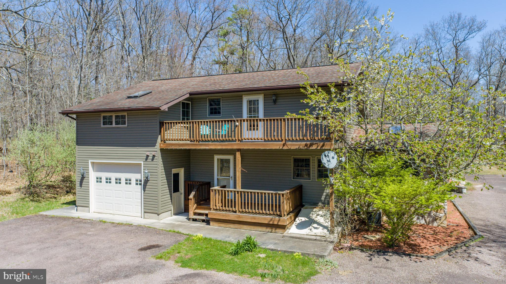 Lake Access Living in Sought-After Sky Valley! Nestled on a peaceful cul-de-sac in the desirable Sky Valley community at Deep Creek Lake, this beautifully updated 4-bedroom, 2.5-bath lake access home offers the perfect blend of rustic charm and modern convenience. Set on a spacious 1.26-acre wooded lot, this home features brand new stainless steel kitchen appliances, granite countertops, and durable LVT flooring throughout for easy lake-life living.
The inviting interior boasts vaulted wood ceilings, a stunning stone fireplace with gas log insert in the main living area, and a cozy wood-burning stove for chilly mountain evenings. Enjoy outdoor relaxation from the upper-level deck balcony or unwind on the back porch with its covered sitting area — ideal for quiet mornings or entertaining guests. A one-car attached garage adds convenience and storage space.
Sky Valley is one of Deep Creek Lake’s most unique lake access communities, featuring boat slip availability through the HOA waitlist, the lake’s only community boat ramp, a private beach with roped-off swim areas and docks, a sport court, playground, fishing pond, and private roads.
Whether you're looking for a full-time residence or a vacation mountain getaway, this home offers lake access, amenities, and privacy all in one. Don’t miss your chance to be part of one of Deep Creek’s most treasured communities!