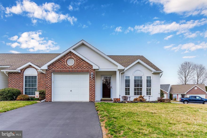 Welcome to your charming new home! This delightful end-of-row townhouse offers a warm and inviting atmosphere with its convenient single-story living. Spanning 1,218 sq. ft. , this home features two spacious bedrooms and two full bathrooms, including a primary bath with a convenient walk-in shower. Step inside to discover a cozy vaulted living room with an abundance of natural light. The heart of the home is the well-appointed kitchen, complete with a peninsula island and pantry, perfect for entertaining. Modern appliances, including a built-in microwave, dishwasher, disposal and gas range, make daily tasks a breeze. Outside, enjoy the beautifully maintained exterior with brick and vinyl siding, complemented by exterior lighting and sidewalks. Relax on your stamped concrete patio, ideal for morning coffee or evening gatherings. The attached garage and paved driveway provide ample parking and convenience. This lovely property is ready to welcome you home—don’t miss your chance to make it yours!