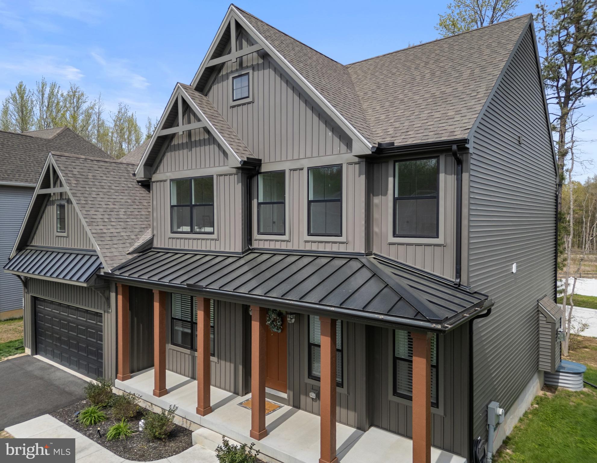 Welcome to 194 Cool Springs Road in North East, MD. This modern upscale home features many premium upgrades rarely found in other homes within this community. As an example, the architectural angles and the color scheme is a dark, rich tone that gives it a sleek and upscale vibe. The front exterior is a vertical board and batten siding with a metal roof accent over the warm wood-tone columns that add character and charm. The black vinyl windows elevate the home’s style, offering a modern, luxurious alternative to the traditional white look. Step through the custom 8-foot door into stunning modern space with sophistication, where soaring 9-foot ceilings create an airy, light-filled atmosphere. To the right, a stylish office with French doors offers privacy, while to the left, an inviting space awaits — perfect for a sitting room or formal dining area. The open-concept living, kitchen, and dining areas blend seamlessly, enhanced by walls of windows that fill the space with light and energy. The gourmet kitchen features upscale cabinetry, sleek hardware, quartz countertops, a large chef’s island, premium appliances — including a gas range with a high-end hood — and a walk-in pantry for effortless organization. The main floor boasts soaring 9' ceilings, elegant high pocket lighting throughout, a stylish half bath, and a convenient two-car garage.
Upstairs, the primary suite is a true retreat, showcasing a wall of windows, chic picture frame molding, and an expansive walk-in closet. The luxurious ensuite bath invites relaxation with a stand-alone soaking tub, a spacious walk-in shower, and dual vanity sinks. The second floor also offers three generously sized bedrooms and an additional full bath, perfectly designed for family or guests. This home was expertly designed in collaboration with a professional interior designer. This home is not your typical cookie cutter home...... it exudes modern sophistication. Why settle for standard when you can move straight into luxury? For just around $300 more per month, you can enjoy a home with all the high-end upgrades — no renovations, no waiting, just effortless, elevated living from day one. This is your opportunity to invest in quality, style, and immediate comfort!