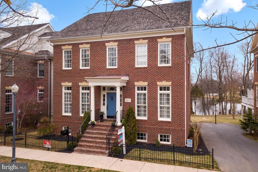 Welcome to this elegant home located in the prestigious Kentlands Community. Impressively located right on Lake Nirvana, this is one of the Kentlands LARGEST Mitchell & Best custom homes. The Leesburg model is a 4-level property & boasts 6 bedrooms & 4.5 baths, with loft; providing  over 6,500 sqft of living space, plenty room for entertaining. Enjoy  lake views from the newer 21x20  Trex Deck with Trex railings and Solar caps. Stunning 10-foot ceilings and hardwood floors on 3 levels of the home. Gourmet kitchen showcasing granite countertops, stainless-steel appliances, 2 dishwashers,  pendant lights, wine rack,  breakfast bar, updated pantry with custom Elfa racks, drawers, and shelving, and much more . Enter through the French doors to your work-from-home office on main level w/custom built ins w/granite counter tops, and floor to ceiling windows. Floor-to-ceiling windows are also in the light filled family room. Upstairs, the large owners suite features a  private sitting room which can be used as a second home office, dual walk-in closets and a large master bathroom. Three additional bedrooms, a full bath along w/a  laundry room complete the upper level.  Escape to the loft area with a separate craft room and another full bath on the 4th level. The fully finished walk-out lower features a large recreation room, an exercise room, a den/bonus room, a  full bath, an unfinished storage space and access to  the  2-car garage. Updates to the home include professional landscaping,  fresh paint in many areas, new carpet, new hardware, several new light fixtures, ceiling fans in many rooms, custom Elfa systems in many closets, and so much more!