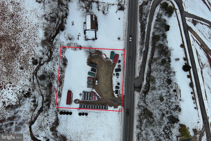 Endless Possibilities in the Desirable Town of Fort Ashby! Situated on almost 1 acre with high-visibility traffic exposure, this versatile property is currently operating as a residual income-producing mini storage facility with 20 units, along with a sales lot for storage sheds. Level topography and public utility availability provide excellent potential for future expansion or redevelopment. Add more rental units, construct a permanent business structure, continue the existing operation, or explore residential possibilities — the choice is yours. All storage sheds currently offered for sale on the property will be removed prior to settlement. A prime opportunity in a thriving location!