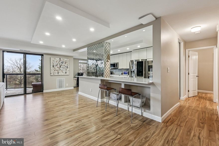 Located in the secure, gated 34-acre Rotonda pet-friendly community, this stunning one-of-a-kind 3 bed/3 full bath unit boasts of tons of updates and newer luxury vinyl plank flooring throughout the entire unit. Two parking spots and storage unit included! Plus, easy access to the elevators! RR Model with Modern & Stylish Upgrades: - Three Updated bathrooms with modern vanities and large format porcelain tile, one bath with tub and two with elegant walk-in showers. All white gourmet kitchen with stainless steel appliances and decorative mirrored tile, tiled backplash, including: *Quartz countertops *Electric cooktop *Dishwasher *Microwave* Double oven * White shaker 42" soft-close cabinets and drawers * in-unit stackable full-size washer/dryer. Recessed lighting throughout. Master Bedroom reconfigured to have huge dressing room. Updated HVAC. Exceptional Community & Amenities: 2 surface parking spots - Tons of outdoor amenities: *Picturesque lakes & gazebo *Manicured walking trails *Gated dog park *Two playgrounds *Three sports courts *DIY car wash *Shaded picnic areas Unbeatable Location & Accessibility: Rotonda’s prime location is directly across from The Boro, featuring Whole Foods, a luxury theater, top-rated restaurants, and an authentic French bakery. It’s also on the Silver Line with two Metro stops and Kaiser Permanente within walking distance. Newly re-zoned school pyramid to Cooper MS and Langley HS! Resort-Style Amenities: - Indoor heated pool (open all year round!) & enormous outdoor pool connected to the domed Community Center - Library, study lounges, and business center - Gym, multipurpose room, and free Wi-Fi in the common areas -Ping pong, billiards, foosball, and saunas - Two unassigned parking spaces on surface lot - 1,600 unassigned spaces throughout the community. Don’t miss this incredible opportunity to live in one of the most sought-after gated communities with unbeatable amenities and location!