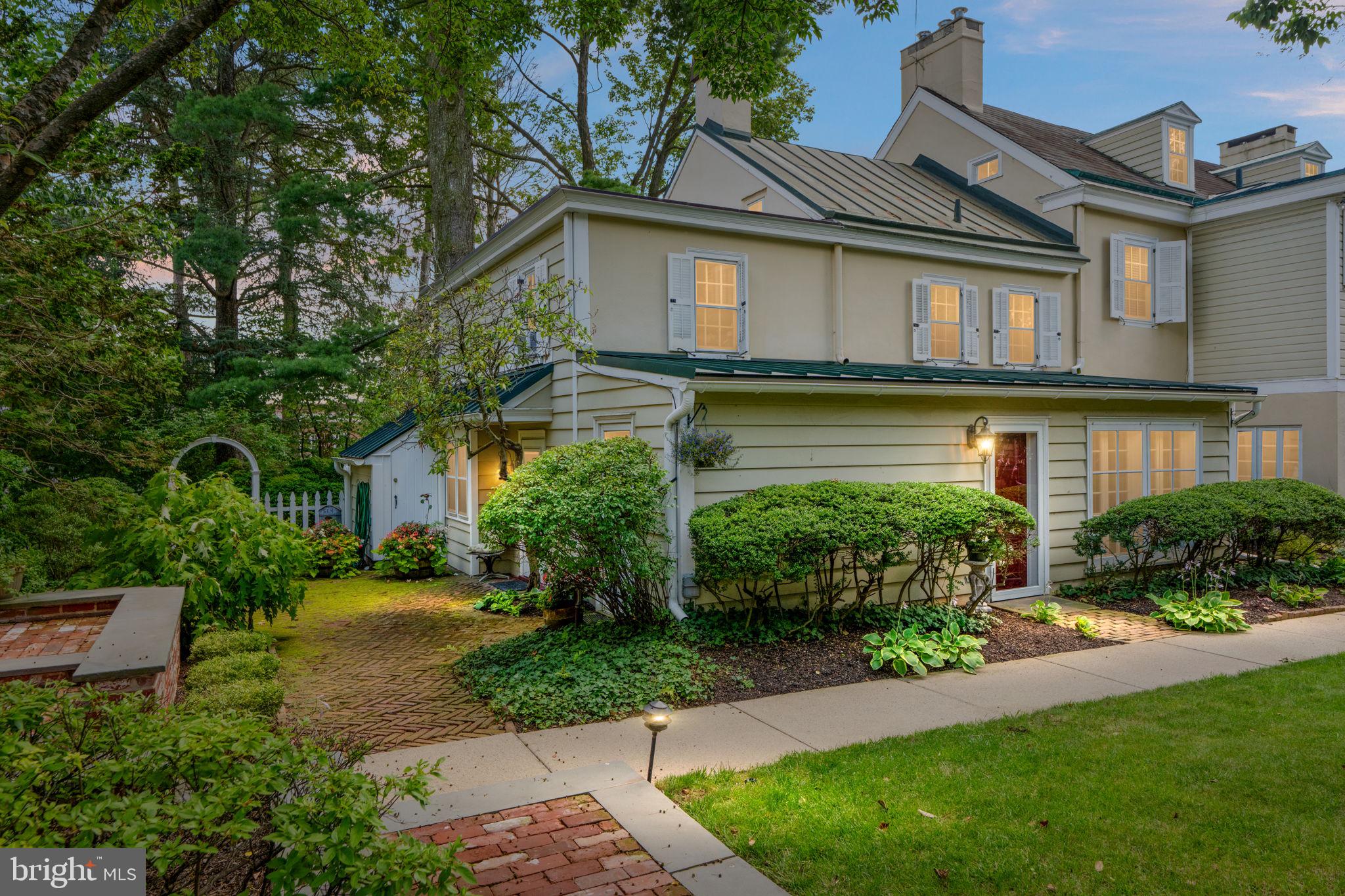 This treasured and historic home is found in the midst of all that Doylestown borough has to offer while providing the peace and tranquility of a private setting and an enchanting garden area that is rarely found. Just steps outside of the garden and the front door of this home and you will be at the County Theater, museum area and shops and well regarded restaurants. You will have a front seat view of the festivals and events that are so enjoyable while still enjoying the peace of a home that feels secluded and private. This home located in Barnes Court condominiums is one of the two residences in the original home that was built in 1804. The manicured community, located near Broad and State Streets, and accessed from Garden Alley, features ten very special homes including those built in 1985 when the community was established. The transformation of this small enclave of homes into a delightful garden spot with a central koi pond and flowering gardens throughout is truly a sight for the eyes and offers a lifestyle of convenience as well beauty. The charm of this home is evident from the front entry into a former porch area, now used as a living room, to the large family room with walk in stone fireplace with an oversized slate hearth, complete with the original oven from when this room was the kitchen for the entire home in 1804. An entrance into the rear garden from an atrium door brings the outside patio and gardens to the interior of this lovely home. The walk in fireplace was converted to gas and is sure to be the central part of this home when relaxing or entertaining. Access to the kitchen with breakfast room area offers a great, flowing floorplan with glimpses of the exterior gardens and sweet spots to sit and enjoy the scenery and your guests. A built in window seat, an extended bay window at the breakfast nook, a door to the side path leading to the garden and a large island for food preparation and entertaining make this home a place to enjoy, entertain, find solitude and live a lifestyle that offers so many options for recreation and the arts. Electric cooktop and wall oven plus a built in microwave and plenty of prep space will allow lots of room for the chef and friends. The laundry room on the first floor with extra closet and built in storage add to the ease of living and places for everything you need nearby. A conveniently located commode is also located on the first floor for ease of owners and guests. The second floor of this home, accessed by original turned stairs features two bedrooms and two baths, again with window views of nature and the gardens. One of the bedrooms is the primary bedroom with an ensuite full bath. Another staircase leads to the third floor loft, which can be used as a bedroom or office, features a walk in closet and built in storage including a window seat for a bird's eye view of town. There is a partial basement with crawl space for storage and lots of closet space in different areas of the home. This low maintenance lifestyle, combined with gardens and spacious rooms will offer an opportunity to live close to town while having space to enjoy and entertain with everything you need nearby.Distinctive features in this well maintained home include original beams in the living room and family room and recessed lighting in the kitchen and family. The Doylestown train station is minutes away, New Hope, Peddlers Village and access to New Jersey, New York and Philadelphia allow for easy commuting and enjoyment. A one year home warranty is included for extra peace of mind. Barnes Court is a lifestyle and a location that is simply unmatched. Do not hesitate to see this home by appointment only.