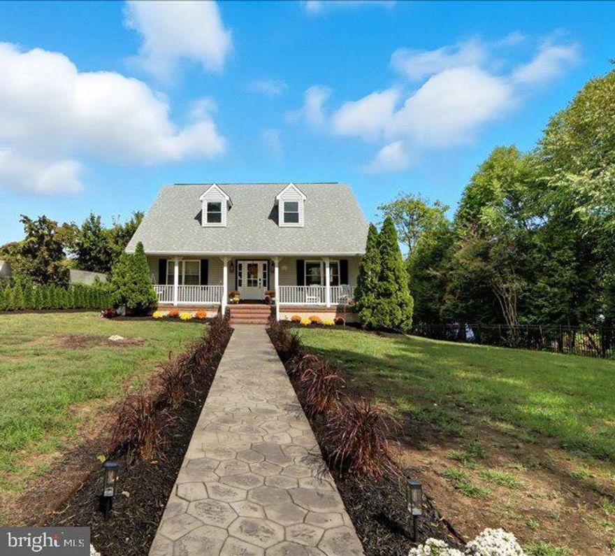 WATERFRONT and a FIRST-FLOOR MASTER!  Super peaceful cove setting! There’s more to this than just beautiful and on the water - there’s a quiet privacy with your distance from the road on the one side and your placement in the cove for your water frontage where waterway traffic is minimal.  You won't find this caliber of home under a million on .72 acres with deep water, pier, sandy beach, public water and sewer and all new!  You're getting both the lifestyle and the quality with this home!  Beautiful open floor plan designed in a new modern farmhouse style that blends charm, warmth, and elegance. From the moment you step inside you’ll find water views.  Rich  wood floors, stone fireplace with custom built-ins, and you have the real feeling of being out on the water with full corner open windows.  The chef’s kitchen is a showstopper—designed for both entertaining and everyday living, while cooking with a view!  The newly finished lower level doubles your living space with a spacious family room, an additional true bedroom and full bath, with a large dedicated laundry suite. Thoughtful updates, including oversized windows and a large sliding door, bring the beauty of the water even closer. Step outside to your peaceful, cove and private pier with 8’ MLW—perfect for boating, fishing, or simply soaking up the scenery. Entertain on your expansive back deck with Maryland’s famous crabs, or enjoy quiet mornings with coffee on your charming covered front porch.

This property is fully surrounded with a low profile iron gated fence that has remote open and close so no getting out of the car to get in and out.  The thoughtful choice of fencing is without any obstruction to your views.  Plenty of parking for gatherings and the addition of a separate 3 car garage with additional recreational space above would be ideal for those frequent guests, kids home for the holidays or maybe a grand at home office space. This home truly exudes luxury, comfort, and the feeling of being on vacation every single day.  The beautiful pictures can't truly convey the essence of this home... so call me for a personal showing!