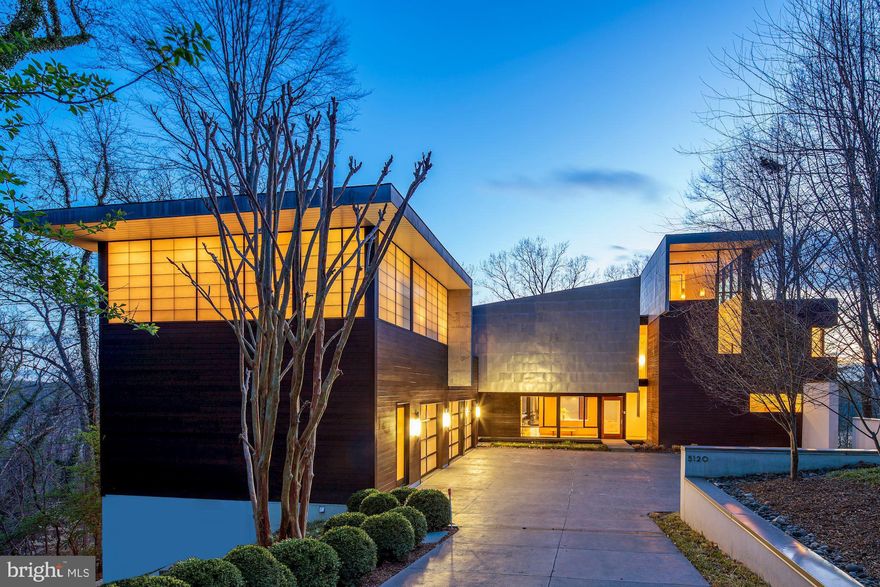 Discover an extraordinary living experience within this residence-  a masterpiece of superb construction and outstanding design seamlessly integrated to harmonize with the surroundings, providing breathtaking river views.  It is truly magnificent.  Stunning and sophisticated, this AIA 2008 Award Winning Custom Contemporary designed by Robert Gurney is perched on the palisades of the Potomac River. Spectacular seasonal views, exceptional privacy and natural beauty abound. This property is crafted with unparalleled architecture and superlative high-grade finishes such as luxurious heated Terrazzo flooring, eco-friendly bamboo, zinc coated stainless steel, red balau siding and other meticulously selected elements.  Intangible, magical features include the ever-evolving hues and shifting light, adding depth and dynamism to the space.  Experience the ultimate home office setup, a separate building offering complete privacy and stunning views overlooking lush woodlands, perfect for productive remote work sessions.  In addition to the exceptional home office space, welcome family and friends to the upper level guest suite offering a cozy sitting area with a gas fireplace and a secluded rooftop deck for their comfort and enjoyment.  After a long day, unwind beside the salt water lap pool complemented by an adjacent fire pit and an outdoor projection screening wall for an unparalleled leisure experience.  Or escape from it all to the covered rooftop deck with a tree house feel and views that go on forever.   Once you step into this home, you won’t want to leave.  You will discover yourself in a tranquil space, irresistibly drawn to linger in its serene embrace.  Ideally located just a short drive from the Nation’s Capitol and within easy access to both major airports:  Ronald Reagan National and Dulles International airports.  Local shopping is around the corner at the redeveloped Westbard Center or Sumner Square.  Take a short drive to the chic boutiques of Georgetown or the enlightening cultural offerings in Washington, DC.  Outdoor enthusiasts will be thrilled with the access to the popular C&O Canal and the Capital Crescent Trail.  Don't miss the incredible video link.  Whitman School Cluster.  Bring your dreams, your wishes and your delights.  It’s here waiting for you!