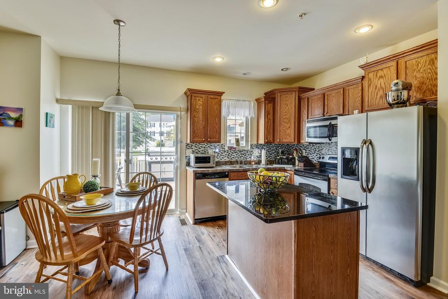 We have declared a winner!  Welcome to the amenity rich community of Tanyard Springs. This home is located in close proximity to the dog park, pool, playground, tennis courts and garden area. You will not be disappointed with the open floor plan, granite counters, kitchen island, stainless steel appliances, wood floors, double vanity sinks in the primary bathroom, front bay window bump out and beautiful maintenance free deck. Additional features include a one car garage, full laundry, storage area and a fenced rear yard.