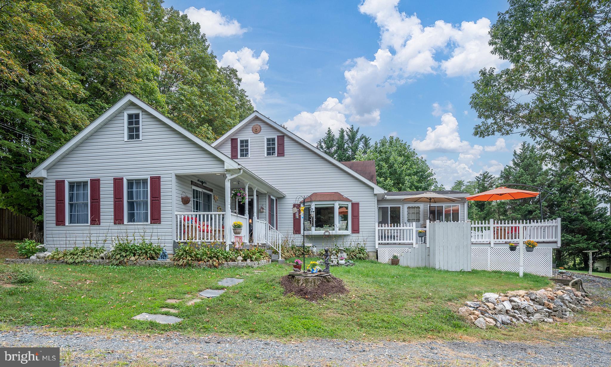 Welcome to 2286 Phillips Mill Road, a charming 5-bedroom, 2.5-bath home situated on over an acre in the heart of Forest Hill. This solidly built home offers more than 3,000 square feet of living space and blends comfort, function, and serene country views.
The main level features three bedrooms, one and a half baths, a spacious living room, a formal dining room with a cozy fireplace, and a bright kitchen with a breakfast nook overlooking the scenic landscape. A large sunroom with a wood stove provides additional living space year-round. Upstairs, you’ll find a private and spacious bedroom, while the finished lower level offers a versatile in-law suite with a second kitchen, another spacious bedroom, full bath, and bonus room that could serve as a 6th bedroom, office, or hobby space.
Outdoor living shines here with a welcoming front porch, expansive deck perfect for entertaining, and multiple outbuildings, including a large barn/garage ideal for storage, hobbies, or even a studio or she-shed. The property feels private and is surrounded on three sides by Lealand Cypress, with Harford Vineyard, open pasture, and cornfields as your backdrop. Sitting at one of the highest elevations in Forest Hill, the home offers sweeping western skyline views which are perfect for sunsets, stargazing, and enjoying peaceful evenings.
Located in the desirable Forest Hill community, you’ll enjoy a tranquil setting while still being just minutes from local shops, dining, schools, and commuter routes. This move-in ready home has so much to love: privacy, space, and views that will take your breath away.