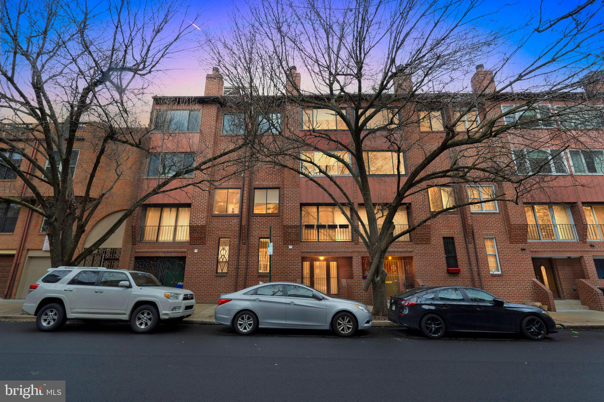 Nestled within the quaint confines of a cobblestone courtyard, within the highly sought-after Logan Square neighborhood, lies an exquisite gem of chic urban living – 209 Logan Court. This distinguished 4-story townhome boasts the luxury of a dedicated, private, off-street parking space, offering an unparalleled blend of convenience and comfort. A sanctuary amidst the bustling cityscape, this residence presents a compelling alternative to the conventional condominium lifestyle, providing the freedom and privacy of a standalone townhome without compromising on contemporary amenities.
The residence was constructed in 1980 and stands as a testament to enduring quality and refined taste. Over the years, it has been thoughtfully upgraded and lovingly cared for, ensuring a living experience of unmatched urban sophistication. The ground level foyer features a spacious coat closet and lovely slate flooring with radiant heat. Beyond the foyer you will find an office and a full bathroom with a stall shower, as well as an ample under- steps storage area for convenience and organization. The ground floor hallway allows easy access to your deeded parking space in the rear of the building. Ascending to the main living floor, you are welcomed by a generously proportioned living room adorned with a charming wood-burning corner fireplace, a Juliet balcony overlooking 23rd Street, complemented by gleaming hardwood floors that exude warmth and character. As you ascend to the next level, the culinary enthusiast will delight in the gourmet kitchen, equipped with top-of-the-line GE Profile stainless steel appliances that elevate the art of cooking, along with beautiful quartz countertops, and soft close cabinets and drawers. A convenient laundry closet, complete with a Bosch stackable washer and dryer, adds a touch of practicality to the space, which is finished by a tastefully appointed powder room. Adjacent to the kitchen is a versatile space which could be a great room, or a dining room. Venturing to the top floor, two bedrooms await. These bedrooms share a well-appointed full hallway bath with a frosted pocket door and Kohler fixtures including a large Kohler soaking tub.
As the crowning jewel of this remarkable residence, a rooftop deck beckons with dramatic views of the city skyline, providing an idyllic setting for al fresco gatherings and serene moments of solitude. Whether savoring a glass of wine as the sun sets over the horizon or marveling at the twinkling lights of center city's towering office buildings, the rooftop deck offers a vantage point unlike any other. This home is a stone’s throw to a world of cultural and recreational opportunities. Just two blocks away lies the iconic Benjamin Franklin Parkway, home to many famous attractions including fabulous fountains and world-class museums. Walk to Trader Joes, Giant, Whole Foods and the Schuylkill River Walking Trail. This home is within the Greenfield Catchment Area, one of the most highly sought after public schools in Philadelphia.
209 Logan Court embodies the epitome of urban sophistication, offering a harmonious blend of style, comfort, and convenience in the heart of Logan Square.