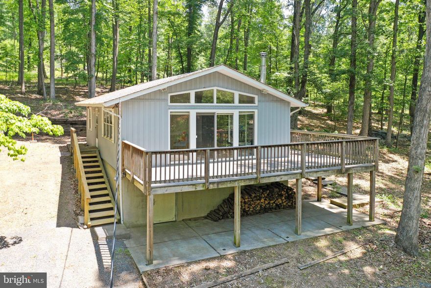 COME AND SEE THIS CHARMING CABIN IN THE WV MOUNTAINS! IDEALLY SET BACK OFF OF A PAVED ROAD OFFERING PLENTY OF PRIVACY WITH THE CONVENIENCE OF A STATE MAINTAINED ENTRANCE INTO THE DRIVEWAY. THE LAND BOASTS MOUNTAIN VIEWS AND PLENTY OF USABLE ACREAGE THAT HAS A TIRE SWING FOR THE KIDS AND THOSE YOUNG AT HEART. YOU WILL HAVE YOUR CHOICE OF OUTDOOR LIVING SPACE WITH A WRAP AROUND DECK AND A COVERED PATIO AREA. SIT IN THE OPEN CONCEPT LIVING AND DINING AREA AND ENJOY THE NATURAL SUNLIGHT THAT POURS INTO THE SPACE FROM THE ABUNDANCE OF WINDOWS AND SLIDING GLASS DOORS. ON COLD NIGHTS, THE WOOD STOVE WILL EFFICIENTLY HEAT THE CABIN. THERE IS A PARTIALLY FINISHED BASEMENT WITH A SECOND FULL SIZED BATHROOM AND A WASHER/DRYER HOOKUP. THE ROOF OF THE CABIN WAS REPLACED IN 2016. THE EXTERIOR DECK STAIRS WERE REPLACED IN THE LAST 6 MONTHS. THE WELL PUMP WAS REPLACED THIS YEAR. A LARGE SHED CONVEYS FOR BONUS STORAGE AREA. THIS PROPERTY MAY BE UTILIZED FOR RENTALS INCLUDING SHORT TERM.