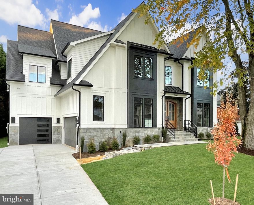 Welcome to 7000 Hector Road, a high-quality, new construction home in the heart of McLean, boasting mature landscaping and 3-car garage!  The 6 Bed/7 Bath meticulously designed home is the latest luxury offering by local, well-established builder, Randhawa Inc. The special lot features a backyard full of mature trees, affording privacy not ordinarily found in new construction and is situated in coveted Broyhill-Langley Estates - a mere stone’s throw from downtown McLean, the Community Center & Library, major commuter routes (I-495/GW Parkway/I-66 & Dulles Toll Road), and schools (Churchill/Cooper/Langley & several private schools.) 
HOME FEATURES:  A flagstone walkway leads you to the threshold of the double 8’ arched mahogany doors and provides a fantastic opportunity to soak in all the main level has to offer such as 10’ ceilings, custom-designed oak flooring, extensive custom woodwork detailing and arched openings. Light beams through the living room’s 8-foot windows, showcasing an eye-catching feature wall.  The powder room features a herringbone white marble floor, black shiplap accent wall and elegant champagne bronze fixtures.  The kitchen offers beautiful cabinets stacked to the ceiling, 48” Subzero refrigerator and Wolf appliances, including a 48” gas range and pot filler.  The kitchen island built with quartz waterfall countertops and an oversized 48” sink w/ Brizo fixtures.  Early morning coffee may be enjoyed on the screened deck or in the large breakfast room which overlooks the backyard and provides access to the private screened deck.  The family room features a coffered ceiling, gas fireplace w/ modern marble surround and access to the wet bar and screened rear deck where owners can enjoy the beautifully landscaped backyard w/ mature trees providing privacy from neighboring homes.  Recognizing today’s modern living -  the oversized mud room features a shower/wash area (suitable for humans or their pets!) complete with custom built-ins/seating and is accessible by both the 2-car and 1-car garage bays.
The sun-filled wide staircase w/ wrought iron wood-capped railings beckons you to the second floor and  leads to the second family room which may also serve as a play area or study lounge.  Thoughtful arched walkways lead from the "second floor family room" to five ensuite bedrooms. Tasteful details abound in each bedroom and bathroom – each finished w/ custom-built closets, luxury tile, and designer fixture selections.   While the secondary bedrooms are impressive - the owner’s bedroom is extra special, featuring two custom closets, a dressing area and large bathroom with on-trend wet room (free standing tub in extra-large enclosed shower space.)  Clear attention to window placement throughout the house give stunning views of the fall foliage from the bedrooms.  
Finally, the finished basement has been primed for entertaining - featuring an entertainment/rec room w/ extra-large wet bar, full-size refrigerator, island for seating and plenty of room for pool table/game tables (LVP flooring). The lower level also features a light-filled bedroom w/ large closet and full bath, Exercise Gym (rubber flooring) and a large Media room (w/ premium carpet).