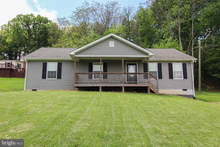They say "Home is where the story begins". Let your story begin in this lovely home on 1 acre.  Come enjoy this spacious open floor plan, where you won't feel closed in.  The kitchen has stainless steel appliances, double sinks, wood cabinets and a center island with extra cabinet space and a place for chairs so you are able to sip your morning coffee informally. The primary suite enjoys a walk-in shower, as well as, a large walk-in closet along with an additional large closet. The two additional bedrooms will more than accommodate your family or friends.  There is a back deck where you can enjoy mother nature and a covered front porch that you can spend time in a rocking chair watching the beauty that surrounds you, including a pond across the street.  Call today to schedule an appointment to see this sweet home.