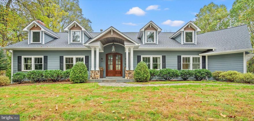 This fully renovated 4-bedroom with flex room, 3.5-bath Craftsman-style home blends classic charm with modern upgrades for a luxurious yet functional retreat. Thoughtful architectural details and decorative trims create a polished aesthetic throughout. Nestled on over two acres, this serene property offers privacy while being just minutes from downtown Oakton, Vienna, Tysons, and Reston.

A private, newly paved driveway leads to the 6,000+ sq. ft. home, featuring a flexible floor plan, a three-car garage, and exquisite outdoor spaces. A grand arched portico, mature landscaping, flagstone pathways, and a tiered deck with panoramic views enhance its curb appeal.

Inside, the foyer impresses with mahogany double doors, soaring ceilings, and elegant moldings. The living and dining rooms flow seamlessly into the gourmet kitchen, which boasts custom cabinetry, granite countertops, high-end GE Profile and Wolf appliances, and a spacious center island. A bright breakfast room with bay windows and a cozy family room with a gas fireplace provide inviting gathering spaces. The main level also includes a sunroom/home office with a fireplace, a stylish powder room, a well-organized mudroom, and a back staircase.

The lower level offers an expansive recreation room with an electric fireplace, a game room with backyard access, and ample storage.

Upstairs, the primary suite is a luxurious retreat with a gas fireplace, cathedral ceiling, and a spa-like ensuite featuring a clawfoot tub, marble shower, dual limestone vanities, and a walk-in closet with shelving. Three additional bedrooms include vaulted ceilings, dormer windows, and built-in storage. A versatile flex room above the garage offers potential as a fifth bedroom or game room. The hall bath is elegantly appointed with marble finishes, while the laundry room features GE appliances and a scenic view. Soundproofed walls ensure a quiet living environment.

This stunning Craftsman home seamlessly blends timeless design with modern convenience, offering an elegant and private sanctuary for sophisticated living and entertaining.

DISCLOSURE:  All information as provided by the current owner/seller and/or third party sources.  The Listing Broker does not guarantee the information describing this property.  All dimensions are approximate; there are various methods of calculating the size (square footage) of the property.  The Listing Broker makes no representations as to the actual size of the unit, regardless of the method used.  Interested parties are advised to independently verify this information through personal inspection or with appropriate professionals.