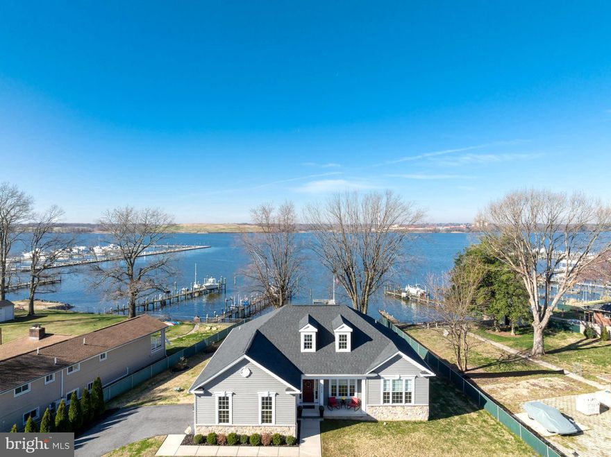 **Amazing Waterfront Rancher built in 2020 by Castle Rock Builders, offering the perfect blend of luxury, comfort, and breathtaking views.  This 3-bedroom, 2-full bath home with a private office features just under 2,000 square feet of beautifully finished living space, along with a massive unfinished walk-out basement offering the potential for nearly 2,000 additional square feet.  Situated on over a half-acre lot with approximately 75 feet of direct waterfront frontage, this property delivers stunning panoramic water views and the ultimate setting for boating, entertaining, or simply relaxing by the water.

From the moment you arrive, the captivating water views set the tone as the inviting front porch welcomes you inside.  Upon entry, French doors lead into a private home office featuring hardwood floors and a tray ceiling—perfect for remote work or a quiet retreat.  Just beyond, a sliding barn door opens to a convenient utility room complete with a full-size washer and dryer, interior access to the basement, and a second door leading to the attached two-car garage.

Continue down the hall into the heart of the home where the open-concept layout shines with gleaming hardwood floors, soaring vaulted ceilings, and recessed lighting throughout.  The fully upgraded gourmet kitchen is truly the centerpiece, boasting a massive 10’ x 5’ center island with Quartz countertops and abundant cabinet storage.  Additional highlights include GE stainless steel appliances, a propane gas range, double-door refrigerator with ice maker and water dispenser, mini wine fridge, undermount sink, 42-inch soft-close cabinetry with pull-outs, and stylish pendant lighting.  The adjacent dining area offers the perfect spot to enjoy your morning coffee while taking in serene water views.  The spacious living area is anchored by a beautiful stone gas fireplace, while the screened-in porch provides a peaceful place to unwind and enjoy stunning sunsets.

The primary suite offers a relaxing retreat with plush carpeting, a ceiling fan, and a spacious walk-in closet. The spa-inspired primary bathroom features ceramic tile flooring, a large double vanity with granite countertops, ample storage, an oversized mirror, a jacuzzi soaking tub, and a separate stand-up shower with built-in seating.

On the opposite side of the home, you’ll find two generously sized bedrooms, both with carpeting and Hunter ceiling fans, along with a full bathroom conveniently located between them.  A half bath is also located just off the main living area for added convenience.

The unfinished walk-out basement offers tremendous potential, with the ability to add up to 1,942 square feet of additional finished living space.  It is already equipped with fully insulated walls, a rough-in for a full bathroom, and a sump pump, making future expansion easy and efficient.

Outdoor and additional features truly set this home apart, including a 76-foot private pier with a 10’ x 18’ platform, multiple mooring poles, durable vinyl bulkheads, and a 500-gallon propane tank.  A storage shed with electric, crown molding, linen and coat closets, and 200-amp electrical service add to the home's functionality and appeal.   Best of all, no flood insurance is required.

Ideally located near the Chesapeake Bay, Hart Miller Island, and the Inner Harbor, this home offers convenient access to some of the area’s best waterfront dining, boating, and recreation.  Priced to sell, this is a rare opportunity to own a truly exceptional waterfront property.  Schedule your private showing today and start living the waterfront lifestyle you’ve always dreamed of.