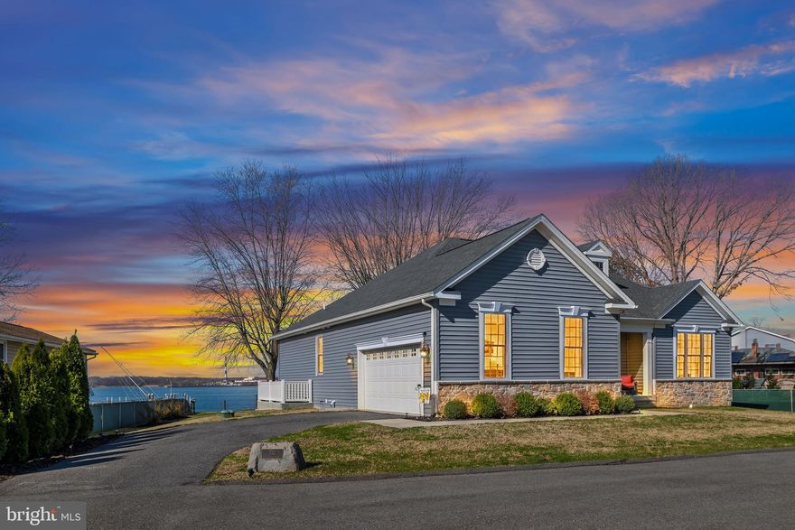 **OPEN HOUSE 3/29/26 FROM 12-2PM**Amazing Waterfront Rancher built in 2020 by Castle Rock Builders, offering the perfect blend of luxury, comfort, and breathtaking views.  This 3-bedroom, 2-full bath home with a private office features just under 2,000 square feet of beautifully finished living space, along with a massive unfinished walk-out basement offering the potential for nearly 2,000 additional square feet.  Situated on over a half-acre lot with approximately 75 feet of direct waterfront frontage, this property delivers stunning panoramic water views and the ultimate setting for boating, entertaining, or simply relaxing by the water.

From the moment you arrive, the captivating water views set the tone as the inviting front porch welcomes you inside.  Upon entry, French doors lead into a private home office featuring hardwood floors and a tray ceiling—perfect for remote work or a quiet retreat.  Just beyond, a sliding barn door opens to a convenient utility room complete with a full-size washer and dryer, interior access to the basement, and a second door leading to the attached two-car garage.

Continue down the hall into the heart of the home where the open-concept layout shines with gleaming hardwood floors, soaring vaulted ceilings, and recessed lighting throughout.  The fully upgraded gourmet kitchen is truly the centerpiece, boasting a massive 10’ x 5’ center island with Quartz countertops and abundant cabinet storage.  Additional highlights include GE stainless steel appliances, a propane gas range, double-door refrigerator with ice maker and water dispenser, mini wine fridge, undermount sink, 42-inch soft-close cabinetry with pull-outs, and stylish pendant lighting.  The adjacent dining area offers the perfect spot to enjoy your morning coffee while taking in serene water views.  The spacious living area is anchored by a beautiful stone gas fireplace, while the screened-in porch provides a peaceful place to unwind and enjoy stunning sunsets.

The primary suite offers a relaxing retreat with plush carpeting, a ceiling fan, and a spacious walk-in closet. The spa-inspired primary bathroom features ceramic tile flooring, a large double vanity with granite countertops, ample storage, an oversized mirror, a jacuzzi soaking tub, and a separate stand-up shower with built-in seating.

On the opposite side of the home, you’ll find two generously sized bedrooms, both with carpeting and Hunter ceiling fans, along with a full bathroom conveniently located between them.  A half bath is also located just off the main living area for added convenience.

The unfinished walk-out basement offers tremendous potential, with the ability to add up to 1,942 square feet of additional finished living space.  It is already equipped with fully insulated walls, a rough-in for a full bathroom, and a sump pump, making future expansion easy and efficient.

Outdoor and additional features truly set this home apart, including a 76-foot private pier with a 10’ x 18’ platform, multiple mooring poles, durable vinyl bulkheads, and a 500-gallon propane tank.  A storage shed with electric, crown molding, linen and coat closets, and 200-amp electrical service add to the home's functionality and appeal.   Best of all, no flood insurance is required.

Ideally located near the Chesapeake Bay, Hart Miller Island, and the Inner Harbor, this home offers convenient access to some of the area’s best waterfront dining, boating, and recreation.  Priced to sell, this is a rare opportunity to own a truly exceptional waterfront property.  Schedule your private showing today and start living the waterfront lifestyle you’ve always dreamed of.