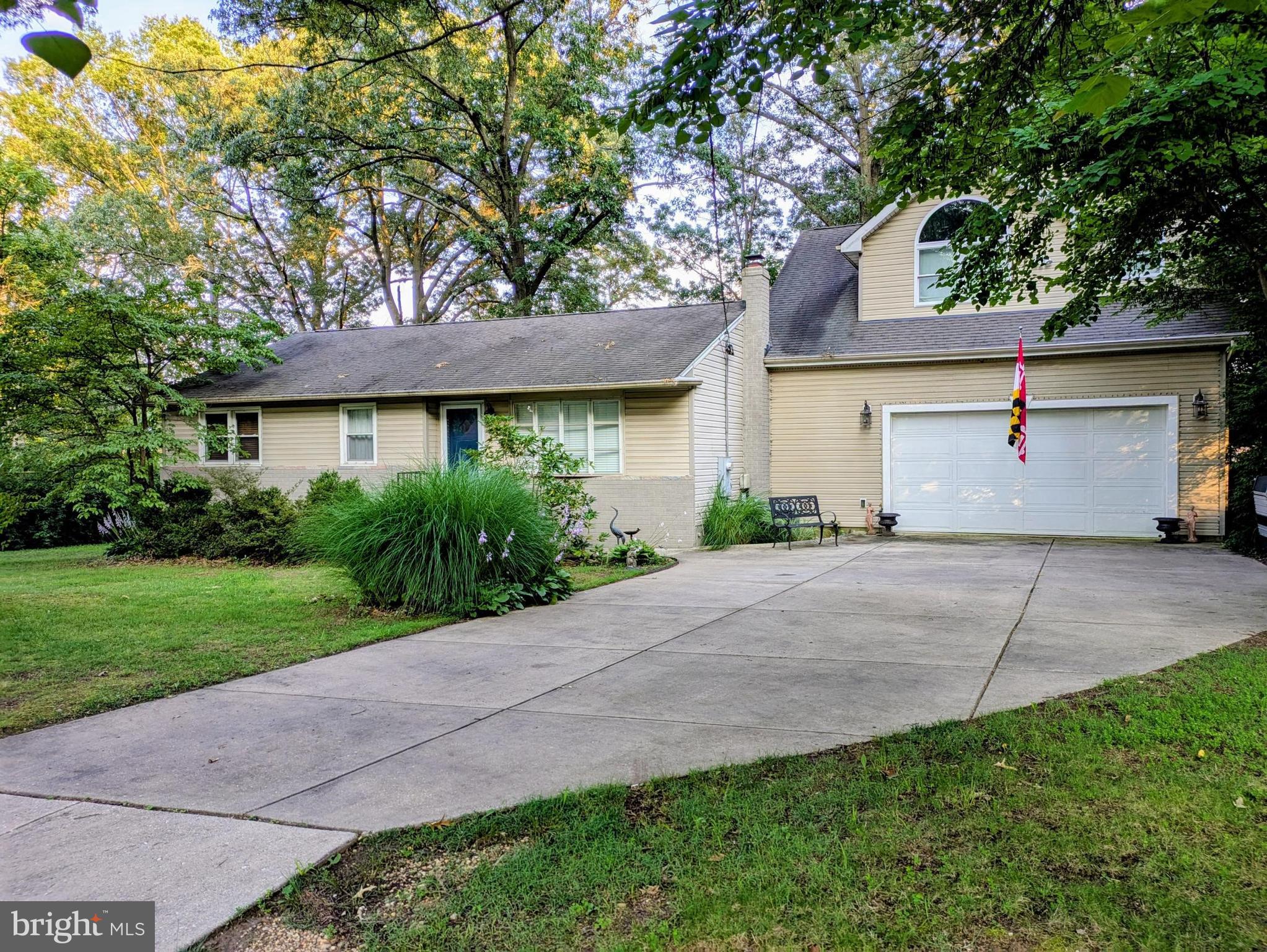 ​This move-in ready 5 bedroom, 3 full bath private oasis is surrounded by perennial landscaping and flowering blooms from Spring to Fall on a half-acre (.46) square, shaded lot. Enjoy low energy costs and a cool basement during the hot Summer months! Home has been fully upgraded, featuring hardwood floors throughout and two recently renovated bathrooms on the main level. The Kitchen has a breakfast bar with a built-in wine cooler and is complete with KraftMaid cabinets. The Butler's Pantry includes additional cabinets with soft close hinges and slide-out drawers for intelligent convenience and additional counter space. Pantry leads to the owner's suite as well as the oversized, foam insulated garage (built in 2009) with overhead storage and large access door to patio, large infinity deck and rear yard. Owner's suite is a quiet retreat that includes a large walk-in closet, private bath, extra storage/shoe closet, sitting area, gas fireplace and private balcony overlooking the rear yard. Basement is newly finished and includes an additional bedroom, large recreational space, custom built bar, laundry area with additional cabinets and storage space with utility sink and new water heater. The home is centrally located in the DMV, close to Metro, Marc train, I-95, ICC, US1, and 295/495, but on a quiet street waiting for you and your family to enjoy for years to come! Seller is offering $5000 towards closing!