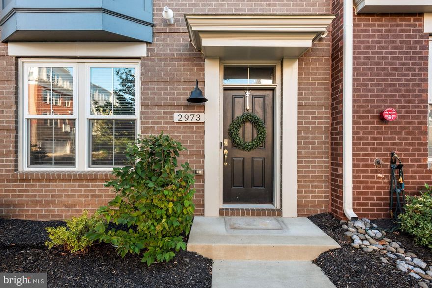 **This home is available again due to an unexpected buyer financing issue, unrelated to the property or seller. Offers are welcome.**

Say hello to 2973 Winter Jack Lane, nestled in the sought-after Marché at Mosaic District, where the ease of city living meets true neighborhood charm.

Built in 2019 by Sekas Homes, this high-end, semi-custom townhome offers four bedrooms, four-and-a-half baths, and nearly 3,000 square feet of beautifully crafted space—a true urban retreat.

Designed across four spacious levels, it blends luxury finishes, functional design, and warm contemporary style—just steps from the vibrant heart of the Mosaic District.

Step inside and you’re greeted by a bright, inviting foyer. To your left, a versatile room easily serves as a fourth bedroom, home office, or guest suite—complete with a custom Murphy bed and full bath nearby. The mudroom connects directly to the oversized two-car garage, finished with epoxy floors, custom storage, and a Tesla charger—the kind of thoughtful details that make life a little easier.

Upstairs, the home opens into a bright, expansive main level designed for both living and entertaining. The living room, anchored by a sleek fireplace, is the perfect spot to unwind. High ceilings and natural light make the space feel open and airy, and the Sonos sound system brings your favorite playlists to life while you cook or entertain...or just chill. 

The chef’s kitchen takes center stage with floor-to-ceiling cabinetry, Calacatta Ultra quartz counters, and an oversized island that invites gathering. High-end Bosch and Thermador appliances, a double oven, a generous pantry, and a custom wine/coffee bar make this kitchen as functional as it is beautiful. Just off the kitchen, a balcony offers a quiet spot for morning coffee or an evening glass of wine. The dining area comfortably accommodates a large table for meals with family and friends.

On the next floor, the primary suite is a calming retreat, complete with power blackout shades, a custom walk-in closet, and a spa-inspired bath featuring dual vanities and a frameless glass shower. Two additional bedrooms, a hall bath, and a separate laundry room with a premium washer and dryer make this level both stylish and convenient.

The top floor extends your living space with a bonus room and wet bar, ideal for movie nights, a home gym, or a creative workspace. 

Step outside to the rooftop terrace—one of the home’s best features—with a 60-inch gas fireplace, motorized awning, and gas line hookup ready for your grill. It’s the kind of space that makes entertaining easy and evenings unforgettable! Throughout the home, you’ll find designer lighting, ceiling fans, Nest thermostats, a security system, and an overall attention to detail that defines quality craftsmanship. The home’s Energy Star certification ensures comfort, sustainability, and efficiency in every season.

And then there’s the location—right across the street from the Mosaic District, one of Northern Virginia’s most vibrant destinations. Step outside and enjoy high-end retail, gourmet dining, and entertainment options, all just moments from your doorstep. Leave your car at home and immerse yourself in the culture, community, and convenience that make Mosaic so special. With easy access to the Metro, I-495, Route 50, and Route 29, plus the nearby INOVA Fairfax Medical Campus, this is truly one of the most connected—and coveted—spots in the DMV. Every detail in this home was designed to elevate daily living—beautifully built, thoughtfully finished, and ideally located.

Come experience the Mosaic lifestyle for yourself—you may never want to leave. 

Photos from prior listing. Tenant-occupied. Except for listed inclusions, seller-owned personal property may be negotiable; offer terms will determine whether items convey or may be available for purchase. Information deemed reliable but not guaranteed.