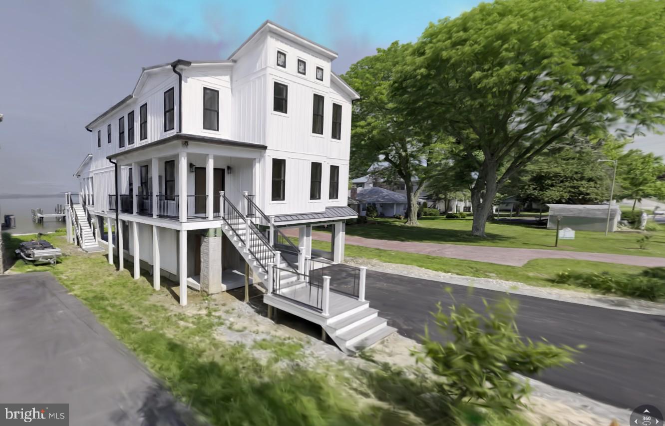 Waterfront Luxury New Construction just in time for SUMMER! Enter through double-door front entry to a thoughtfully designed space seamlessly blending style & function. Modern open concept luxury floorplan w/opulent finishes, high ceilings, & abundance of natural light. Home features an array of windows to enhance its waterfront views and create a bright, airy ambiance throughout. 5 spacious bedrooms, thoughtfully designed for comfort and luxury. The owner’s suite is a sanctuary of comfort and elegance, featuring soaring ceilings that create an open, airy ambiance designed for ultimate relaxation, complete with dual walk-in closets, offering generous storage & organization. Opulent owner’s bath provides a spa-like experience with premium finishes & a tranquil atmosphere. Enjoy a sun-drenched sitting area, flanked by windows that offer panoramic views of the North East River. A separate ensuite offers a private retreat, complete with a dedicated full bath, ensuring convenience and comfort for guests or family members. The additional bedrooms are generously sized, offering ample closet space and large windows to maximize natural light. Home features 2 luxurious spa baths w/ walk-in Roman-style showers, premium imported tiles, and elegant fixtures. A gourmet chef's dream, this kitchen is a harmonious blend of functionality and sophistication. It features imported, custom-designed cabinets w/ample storage, complemented by stunning quartz countertops w/show-stopping waterfall island & professional quality appliances including a WOLF gas stove top w/built-in steamer. Walk-in pantry and prep station, ideal for those who love to cook. The centerpiece is a sleek farm sink paired with premium fixtures. Floating custom imported Asian inspired cabinets add a touch of modern elegance, while the open layout seamlessly connects the living and dining areas, making it perfect for culinary adventures. Designed to captivate and impress, the living areas feature an open concept layout with an emphasis on breathtaking views of the North East River. The great room boasts expansive, window-flanked walls that flood the space with natural light and create a seamless connection to the outdoor surroundings. A covered main living level deck extends the living space, perfect for alfresco dining or enjoying serene waterfront sunsets. Anchoring the room is an elegant electric fireplace with a handcrafted wood surround, serving as both a focal point and a cozy retreat. Custom-built wall curio adds a refined touch of sophistication, ideal for showcasing treasured art or collectibles. These living areas are meticulously crafted to combine luxury, comfort, and functionality, making them the heart of the home and a true haven for relaxation and entertainment. Step into a beautifully designed private office space, ideally situated at the main front door entry for maximum privacy and convenience. This sophisticated office features a custom-built-in double desk, offering multiple workstations, w/built-in shelving , ensuring an organized and tidy environment. 3rd level Laundry is both spacious and convenient, featuring custom shelving to keep organized and within easy reach. Bathed in natural light, the bright, airy atmosphere makes laundry feel less like a chore. Elegantly housed behind sliding barn doors, seamlessly blending the home’s aesthetic. Spacious 3-vehicle moisture barrier vinyl covered parking garage designed w/convenience & security in mind w/steel security entry doors, ample storage & direct access to the covered lower patio, seamlessly connecting to the rear yard. Calling the Water Enthusiast! Property features a new double pier – perfect for mooring multiple vessels . This home offers a rare combination of exceptional design, functional spaces, and luxurious finishes, making it an ideal choice for those who appreciate both comfort and sophistication.