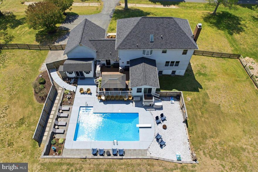COMING SOON SATURDAY 4/25 don't miss this Northern Calvert County Stunner!  No need to go on vacation when you can just live here in this true backyard OASIS! These METICULOUS  Sellers have not missed a detail when it comes to creating a space to truly entertain. Relax under your gazebo on your huge TREK deck overlooking your private IN-GROUND POOL. Play corn hole in its designated space, or sit in your super cute tiki bar attached to the pool area.  Extensive hardscaping & retaining walls offer added privacy. The backyard is also quite expansive & fully fenced-so many options! Inside you will find a solid home with loads of updates over the years.  You are greeted with a large formal dining room & separate living room.  The heart of your home - the kitchen, offers  everything you need to cook up a wonderful meal; lots of prep space, rich cream colored cabinets, granite counters & stainless steel appliances. The kitchen opens to the step down family room with cozy gas fireplace, as well as a BEAUTIFUL sunroom that just makes you happy to sit in.  Upstairs you will find 4 great  sized bedrooms, a recently remodeled hall bath & primary suite with a large walk in shower, dual vanity & separate closets (both in 2023.) New hardwoods run throughout the upper level. The lower level was also fully remodeled in fall 2023. Here you will find a complete IN-LAW SUITE (or possible rental unit )with separate entrance, full kitchen, recreation space, bedroom #5 & full bath.  Other major system updates to include: NEW ROOF 2020, HVAC replaced 2022, water heater 2023, well tank 2023.  Many other updates to lighting, fixtures, fresh paint in most of the house, pool cover replaced 2024, washer & dryer 2021, etc. For a full list please check the documents section. This true GEM offers single family or the versatility of multi general living. Located  1/4 mile from Rt 4 for easy commuting & all the conveniences of Dunkirk. Don't miss it!
