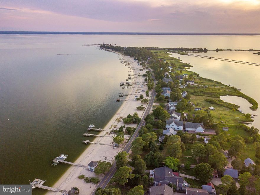 Welcome home to your very own slice of heaven! This beautiful water view and water access home has it all, located just steps off of one of the area's only white sand beaches. A true Southern Maryland treasure, as this beauty comes with deeded beach/pier access. Sip your morning coffee while you overlook the Potomac River. Charm your guests in the gorgeous open concept living space with sun-drenched trex decks and a wonderful trex screened porch off the kitchen and private office/bedroom.  Granite countertops and hardwood floors on the main, as well as a gas fireplace and large walk in pantry.  Take advantage of all of the opportunities the first floor has to offer-- entertain at the built in bar, while watching the game, or pick hard crabs and play corn hole in the comforts of air conditioning .  Additionally, the first floor has loads of storage space and an outside shower, all for your convenience. This lovely home has all the conveniences of living on the water, including local crabbing and fishing at your fingertips. For peace of mind, buried invisible fence line will convey.  Come see for yourself and start vacationing every day of the year!   ***Adjacent .5+ acre lot, with permit in hand, also available for purchase! Lot  permit allows immediate construction of guest house, in-law apartment or income producing VRBO**
