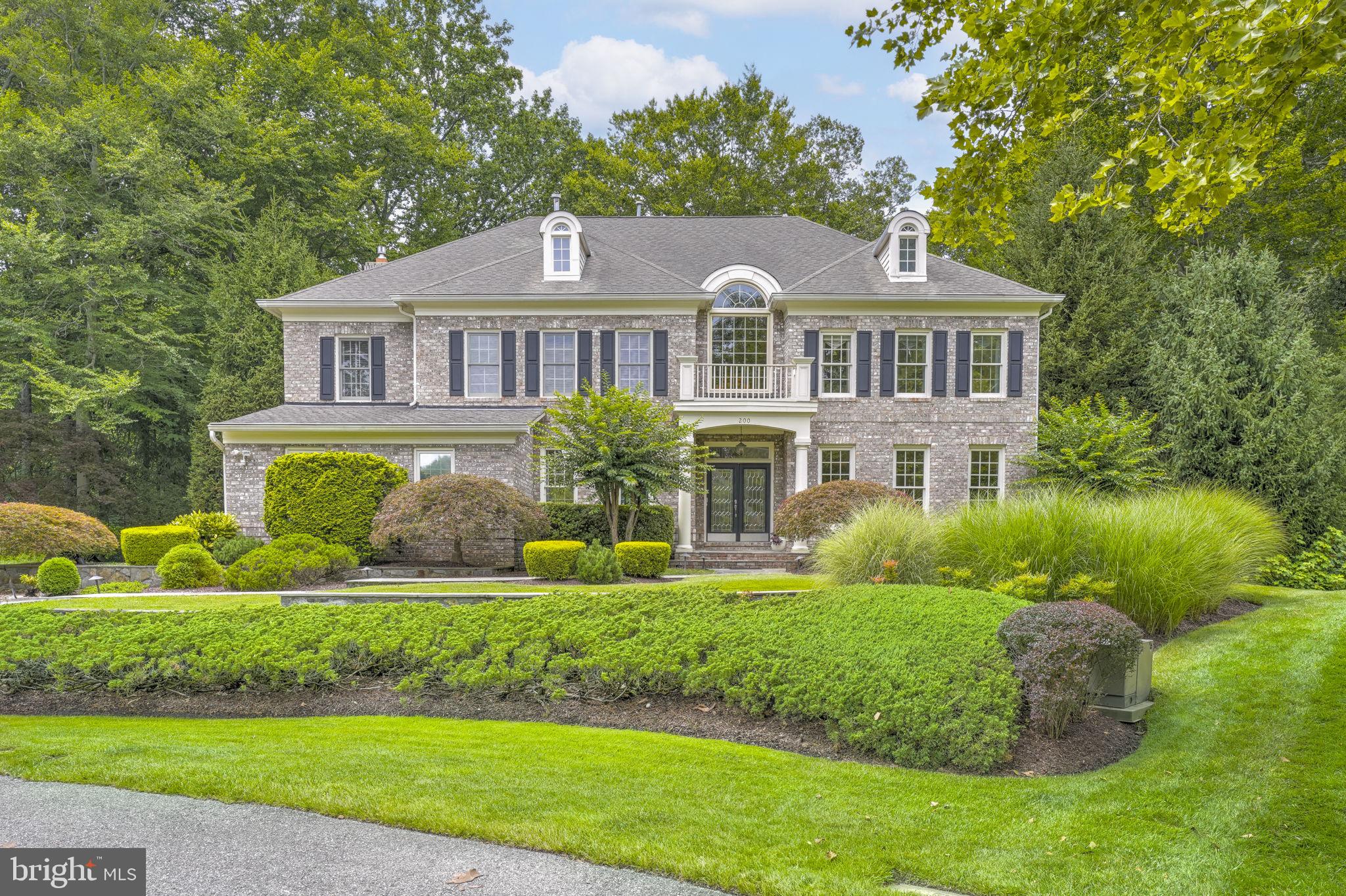 Located on a quiet cul-de-sac in The Preserve at South River Colony, this elegant all-brick colonial offers over 6,000 square feet of finished living space on just under an acre, with lush landscaping and private, wooded views. The bucolic surroundings offer a peaceful retreat for nature enthusiasts, with year-round opportunities to observe birds and local wildlife. The professionally designed backyard - supported by a 15-zone, 75-head irrigation system - features tiered levels, mature plantings, and a canopy of trees that enhance the serene setting. Highlights include an 8,000-gallon stacked-stone pond with waterfall and chemical-free UV light water purification system, and a horseshoe court with regulation pits. Multiple shaded seating areas, a manicured side lawn, and plantings designed to delight in all seasons create unique and welcoming spaces for relaxing and entertaining.
Inside, the front entry showcases marble flooring, soaring ceilings, an Italian alabaster glass chandelier, and a curved staircase leading to the second floor. This 4 bedroom, 5.5 bath home features hand-painted ceilings with a refined faux-marble finish, custom indoor wooden shutters, hardwood floors, two gas fireplaces, classic wainscoting, and detailed millwork. The spacious second floor primary suite features a tray ceiling, two walk-in closets, and a soaking tub with views of the woods. The open kitchen includes dual Bosch dishwashers, a Sub-Zero refrigerator, and an island with cooktop and seating. It adjoins the two-story family room and a sky-lit sunroom that opens out to a gracious, wrap-around back porch, connecting the home to its outdoor setting.
The finished, walk-out lower level has a full bath, large recreation room, wet bar, additional guest room, and abundant storage. The two-car attached garage includes ample built-in shelving and a 32Amp EV charger. The home is supported by a gas powered generator with transfer station. The yard has a buried electric dog fence. NEW ROOF scheduled for installation in August 2025 - 40-year GAF Timberline HDZ shingle roof with transferable warranty.
Sited on a generous lot with public water, sewer, and natural gas, this home is part of the South River Colony Conservancy—an amenity-rich, beautifully maintained community just south of Annapolis. Amenities include a pool with swim league, tennis and pickleball courts, walking trails, and tot lots. The neighborhood is home to The Golf Club at South River, a private members-only 18-hole course with restaurant, fitness center, and golf simulator lounge. The location is convenient to historic Annapolis, the South River, Washington, D.C., and Northern Virginia.