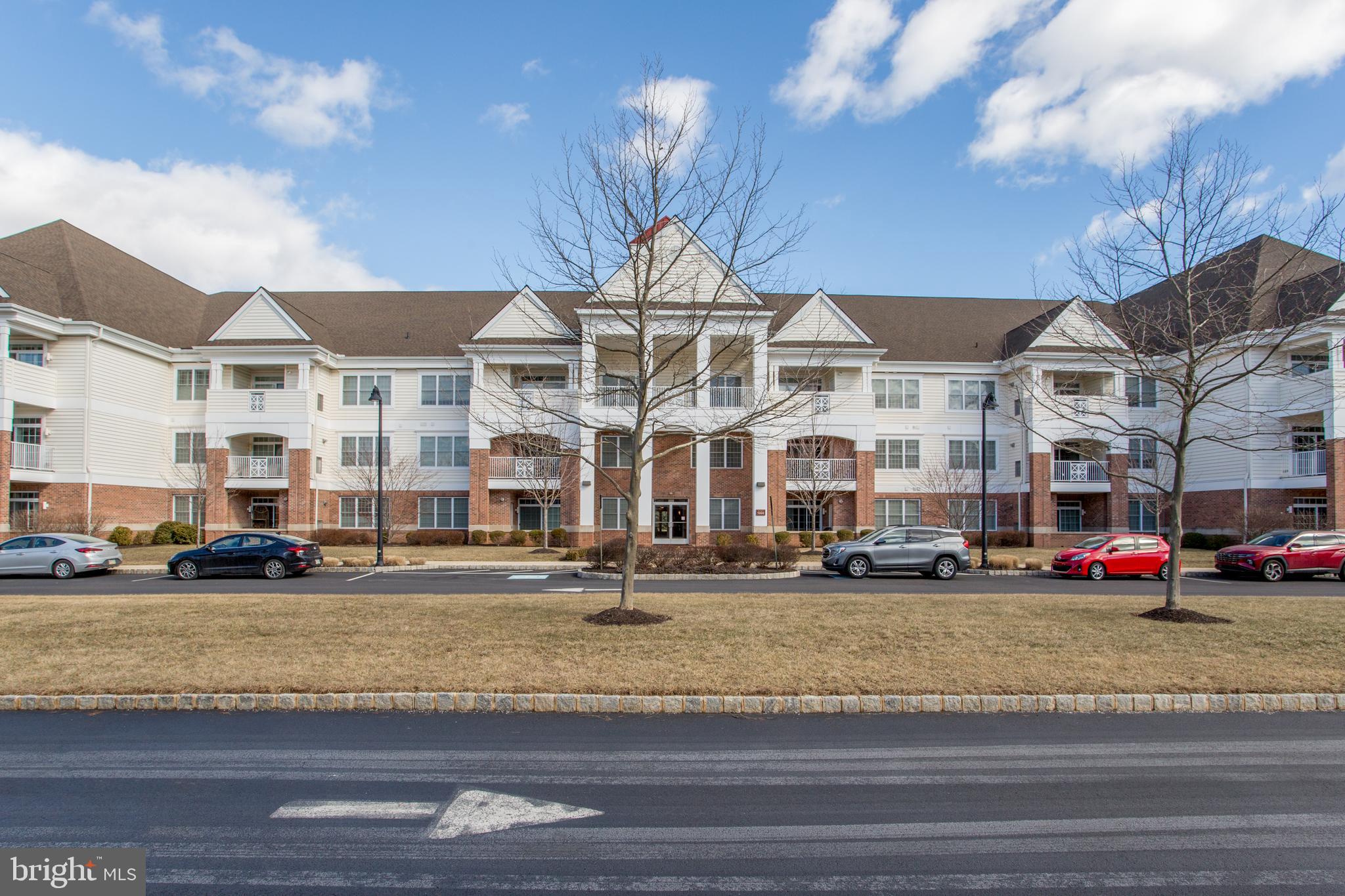 You won't want to miss this stunning 2 bedroom, 2 bath condo on the second floor of one of the newest buildings at Meridian of Valley Square, a very popular 55+ community in Bucks County. The spacious, light-filled dining room and living room feature gleaming hardwood floors, dry bar, corner fireplace, and sliding glass doors to a large balcony with beautiful views of the landscape. The gourmet kitchen boasts high-end stainless steel appliances including a gas cooktop, white custom cabinetry, gorgeous granite countertops and an island with seating for four. The primary suite, also with hardwood floors, includes a large sitting area as well as multiple custom closets. The bathroom is gorgeous with a 2-sink vanity, walk-in shower with seat, and dressing table. The second bedroom is on the opposite side of the condo and also has hardwood floors and a large custom closet. The adjacent bathroom is beautifully appointed and is next to the laundry room with full-size stackable washer and dryer as well as a utility sink. The condo has its own garage on the ground floor, with inside access, and a separate storage unit nearby. The pet-friendly community offers many amenities including secure entrances, elevators, walking and jogging trails, large outdoor saltwater pool, and a clubhouse with billiard room, fitness center, library, and more. One can walk to Wegman's Food Market and the shops and restaurants at Valley Square. Easy access to major commuting routes and a short drive to Doylestown Borough and all it has to offer.