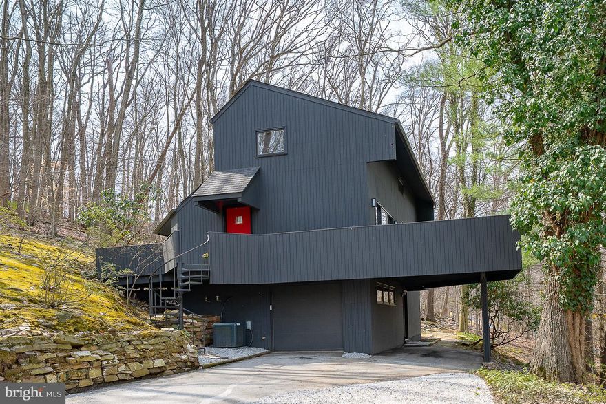 Nestled on 1.08 private wooded acres in Gulph Mills, this striking contemporary residence offers a rare blend of architectural character, natural surroundings, and modern updates. Integrated into the hillside to enhance its connection to the landscape, the home is designed to embrace its setting, with expansive glass, skylights, and multiple sliding doors that create a seamless connection between indoor living spaces and the surrounding decks and landscape.

Built in 1973, this home showcases the hallmark elements of contemporary design, including clean lines, open living spaces, dramatic ceiling heights, and an abundance of natural light throughout its 2,153 square feet. The main living area is anchored by a floor-to-ceiling fireplace, serving as a bold focal point for both the living and dining spaces while enhancing the home’s architectural presence.

The updated kitchen blends modern functionality with the home’s design aesthetic and features brand new stainless steel double ovens, a new dishwasher, and a newer refrigerator. New luxury vinyl flooring throughout the main level and stairs complements the home’s clean, modern feel.

The home offers 3 bedrooms, 2.5 baths, and flexible bonus space ideal for a fourth bedroom, office, or studio. The primary suite is a true retreat, highlighted by a distinctive bubble window overlooking the wooded setting, along with fantastic walk-in closet as well as an updated en-suite bath featuring a large, tiled shower and dual sinks.

The upper level includes a loft-style room and an additional bedroom with soaring ceilings and a full hall bath, further emphasizing the home’s open and airy design.  A lower level provides additional versatile space for a family room, gym, or media area. Thoughtful built-ins and generous closet space throughout the home provide both functionality and ample storage.

Outdoor living is a defining feature, with decks surrounding the home and offering multiple vantage points to enjoy the peaceful, natural surroundings. Additional amenities include an attached one-car garage with additional covered parking.

Conveniently located just minutes from major routes (76 & 476), SEPTA, Wayne, and King of Prussia, and situated within the Upper Merion School District, this home also benefits from proximity to the expansive Upper Merion Community Center, a 70,000-square-foot facility offering a wide range of programs and amenities. Nature trails, downtown Wayne, numerous colleges and universities are all within a short drive.

This is a rare opportunity to own a true contemporary home—where architectural design, natural light, and a private setting come together in a premier Main Line location. 

**Showings are by Appointment Only - Please contact your Buyer Agent to schedule an appointment.  You may also contact Listing Agent regarding scheduling an appointment.**