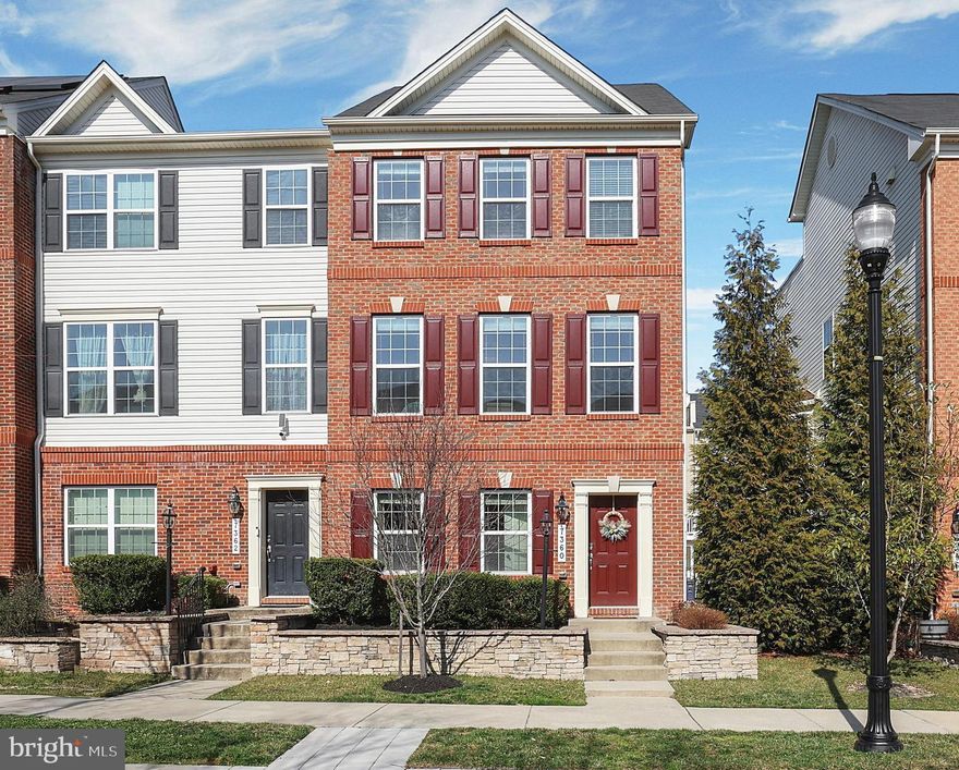 Welcome to this exceptional end-of-row townhome, a stunning four-level residence built by Lennar in the highly sought-after Oxford Square community. Designed with innovation and sustainability in mind, this home showcases cutting-edge construction techniques that prioritize energy efficiency, water conservation, and environmental responsibility. A sophisticated brick façade with a striking stone water table, complemented by meticulously manicured landscaping, creates an elegant first impression. Stepping inside, you are welcomed by a bright and airy interior featuring a refined neutral color palette and gleaming tiled flooring. The entry-level offers an entry level bedroom with engineered hardwood flooring and fresh paint, perfect as a guest suite or home office. This level also includes an upgraded half bath and direct access to the two-car garage, which offers additional storage beneath the staircase. Ascending the newly carpeted staircase, you’ll arrive at the main living area, designed for both functionality and sophistication. The gourmet kitchen is a chef’s dream, featuring stainless steel appliances, luxurious granite countertops, a generous island, and custom 42” Snow White cabinetry. A large double-door pantry ensures ample storage, while the adjacent breakfast nook, bathed in natural light from an elegant chandelier, offers private access to your future deck. The sun-drenched family room, with its warm engineered hardwood floors and neutral tones, provides an inviting space for relaxation and entertaining. A stylish half bath completes this level. The third floor is dedicated to your private living quarters. The owner’s suite serves as a tranquil retreat, offering a walk-in closet, brand-new carpeting, and a spa-inspired ensuite bath featuring dual granite vanities, a walk-in shower, and a private water closet. Two additional bedrooms, each outfitted with ceiling fans and plush new carpeting, share a beautifully appointed full bathroom with a tub-shower combination. A dedicated laundry room adds to the convenience of this level. The top level presents a remarkable recreational space with direct access to a private rooftop deck, providing the perfect setting for relaxation or entertaining under the stars. Beyond its elegant interiors, this home is thoughtfully designed for superior efficiency, boasting a 92% efficient gas heating system, high-efficiency HVAC, Tyvek HomeWrap, dual-pane Low-E windows, and premium insulation throughout. Additional features include a sealed air barrier and ductwork for enhanced climate control, an insulated steel garage door, and durable 35-year architectural roof shingles.
Situated for effortless commuting, this residence is just minutes from major highways, offering convenient access to Baltimore and Washington, D.C.. Residents also enjoy the exclusive private shuttle to the Dorsey MARC Station and the benefit of living near Howard County’s newest top-rated schools. The Oxford Square community enhances the lifestyle with resort-style amenities, including a swimming pool, state-of-the-art fitness center, basketball courts, playfields, and lush green spaces.
This extraordinary home offers the perfect blend of luxury, comfort, and convenience in one of the area’s most prestigious communities. Don't miss this rare opportunity—schedule your private tour today!