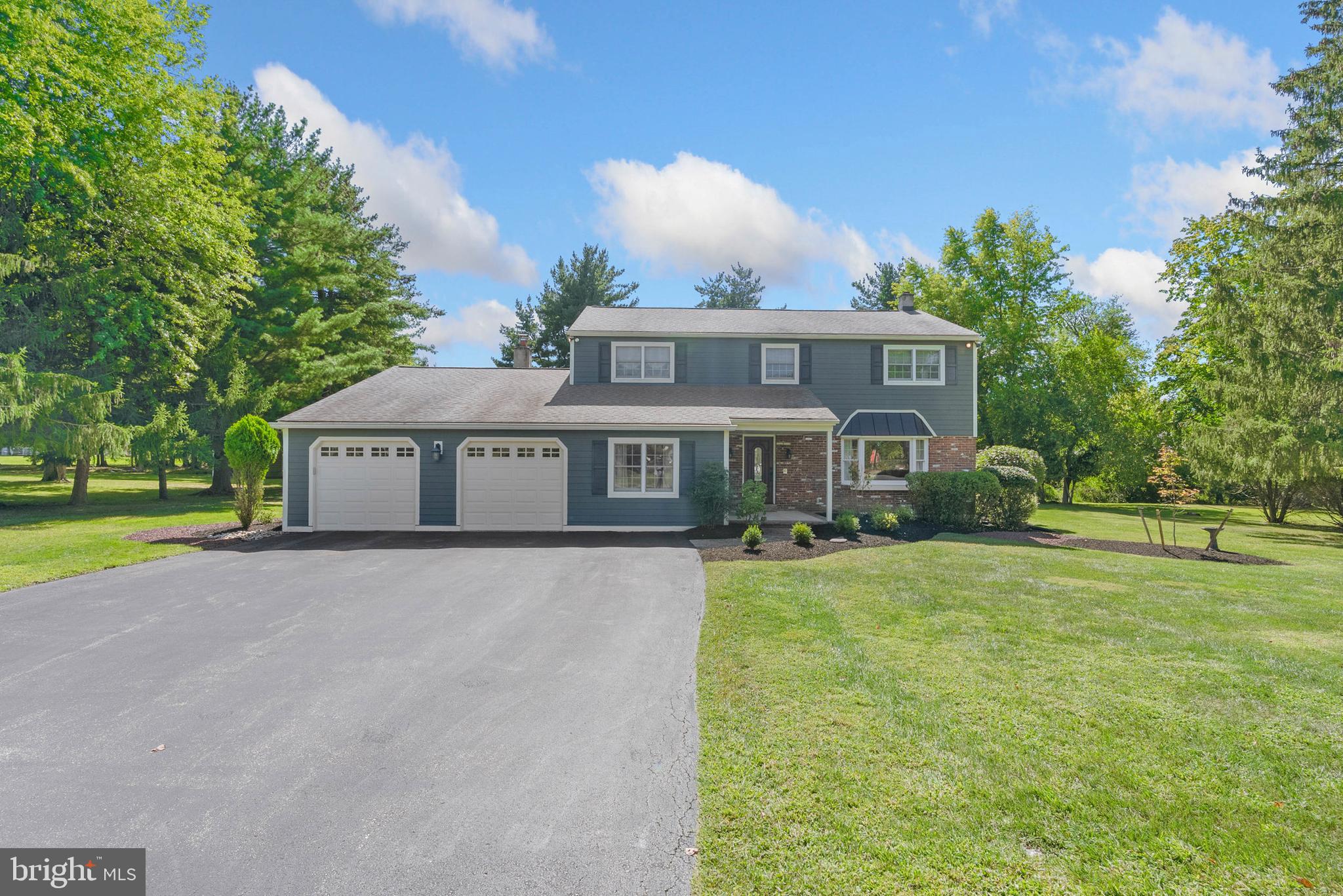 Located on an idyllic, tree-lined street in Blue Bell's sought-after Canterbury Park neighborhood, you'll find 728 Hoover Rd. This move-in-ready, 2,516 sqft home offers 5 bedrooms, 2.5 bathrooms, a finished basement, a sprawling yard and paver patio made for entertaining, an oversized 2-car garage, and placement within the top-rated Wissahickon School District. Out front, charming curb appeal is displayed in the vibrant blue-gray siding, matching shutters, red brick, lush lawn, manicured shrubbery, and a welcoming porch. A tile foyer with a coat closet greets you inside. To the right, French doors reveal a formal living room with modern floors and picturesque bay windows. The heart of the home is sure to be the open kitchen and den at the rear of the main level. The gleaming chef's kitchen is fitted with generous custom cabinetry and granite counters, stainless steel appliances, dual sinks, a tile backsplash, and breakfast bar seating for 4+. At the center is a dining area overlooking the rear yard. Completing the space is a large family room anchored by a brick fireplace mantel. From here, there's access to a powder room, a spacious bedroom, and a laundry room that connects to the garage and attic storage. More living space is found in the finished basement, perfect for a gym or playroom. Up on the second level, there's a large primary suite with a walk-in closet and a spa-like ensuite bathroom boasting a double vanity, a soaking tub, and a glass-enclosed rainfall shower. Three more bright, spacious bedrooms with custom closets share a full hall bathroom. In addition to everything inside, the spectacular backyard serves as a personal retreat well into the fall months. This thoughtfully designed outdoor living space has a covered patio with ceiling fans for relaxing, a grilling station, a spot for al fresco dining, a fire pit for cool nights, and an expansive, securely fenced yard for play. 728 Hoover Rd's fantastic location is minutes from restaurants, shopping centers, parks, golf clubs, and Blue Bell Elementary School along Skippack Pike. Montgomery County Community College and the Plymouth Meeting Mall are also close, plus there's easy access to the PA Turnpike and the NE Extension. Schedule your tour today!