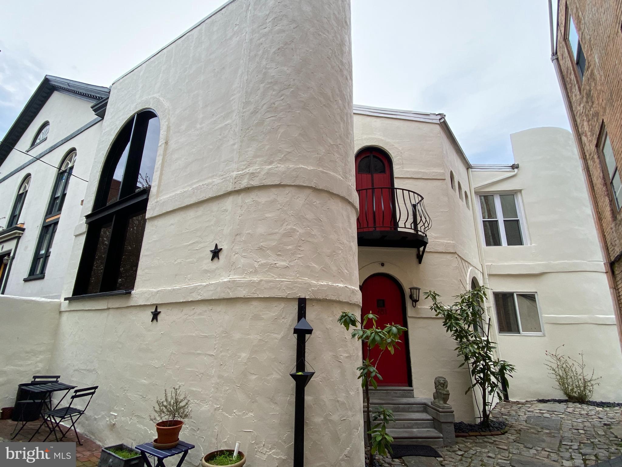 Designer like 150+year-old home known as "The Castle in Candle Court" is one of Philly's most unique homes in a garden courtyard setting. This home was completely remodeled approximately ten years ago. It features 2200 Sq. Ft, 2 bedrooms, 1.5 baths, 2 spacious outdoor decks and 1 car deeded gated parking. It offers open loft-like dramatic space. Perfect for the art collector. The large and inviting foyer opens into a 28-foot living room with soaring 22-foot ceilings with a huge skylight. A formal dining room with cozy sitting nook + a set of atrium doors opening onto the walk out two-level deck (perfect for dining al fresco). The eat in kitchen offers lots of cabinetry, high end appliances, copper backsplash, plus a large island and opens onto the deck overlooking the gardens. This first level is accented with good closet space, designer lighting, old Spanish tiles, hardwood floors, powder room and a separate comfortable family room with fireplace. A 15-foot window (with custom electric shade) allowing wonderful natural light + multiple large walls for art. The impressive wide floating stairs to the second level introduces you to the den/study/second bedroom. The main suite features high cathedral ceilings, reclaimed wood beams, closets and an arched door which opens onto a Juliet balcony overlooking the cobblestone walk. The spa-like master bath has an oversized walk-in sunken shower, a separate soaking tub, granite topped vanity with 2 sinks + extra closets and storage space and a private water closet. The atrium door on this level opens onto a second wonderful large deck (perfect for morning coffee or evening snacks). The finished lower level makes for an office or den, and also has laundry, mechanicals and storage. This Jewel has been freshly painted inside and out. ABOUT THE NEIGHBORHOOD QUEEN VILLAGE: Either you found it by thorough research or plain luck. IT IS THE BEST. Also found in the Blue-Ribbon Award Winning Meredith Catchment. Make your appointment today.